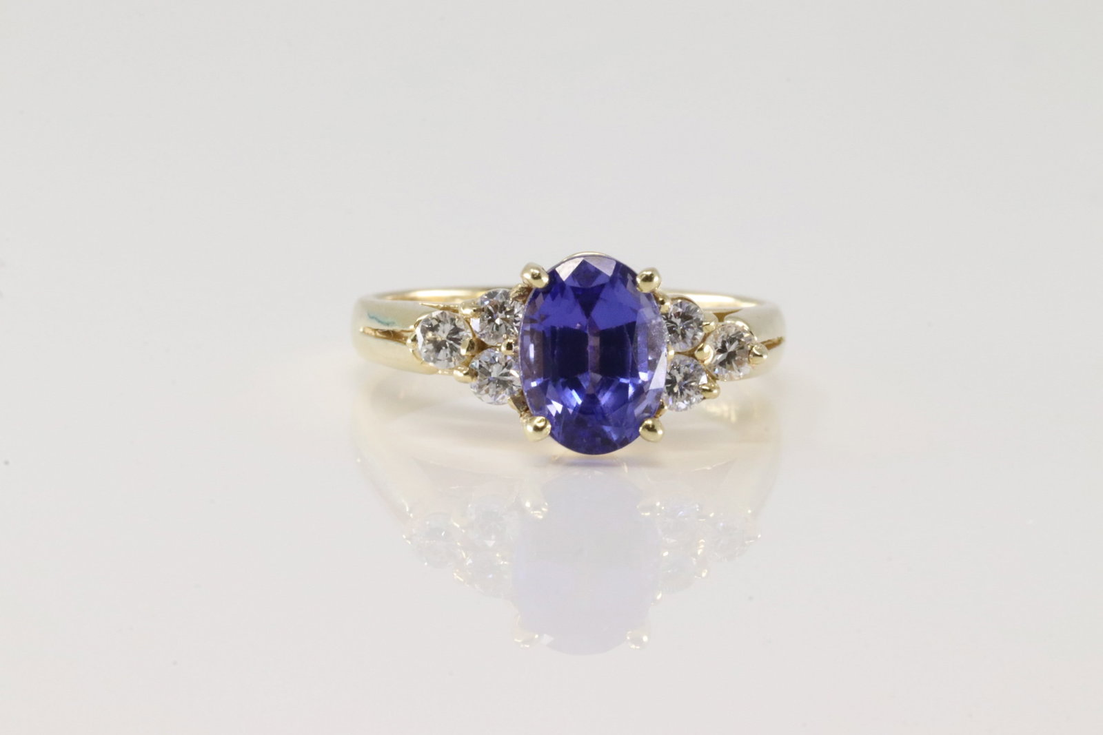 Sapphire & Diamond Ring 14Kt.: Ladies 14Kt Yellow Gold Sapphire & Diamond Ring. This ring has oval sapphire with 8 brilliants diamonds. Ring size: 6.00. Total weight: 6.00.