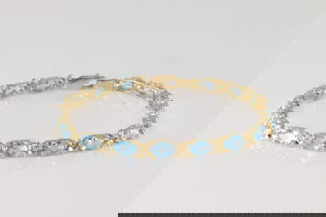 Blue Topaz Bracelet 14Kt.: 14Kt Yellow Gold Blue Topaz Bracelet. This charming bracelet has 17 oval blue topaz gemstone. Bracelet length: 8.00" Total weight: 6.40 Grams.