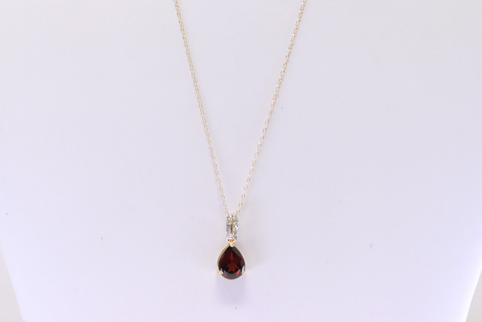 Garnet & Diamond Pendant / Necklace 10Kt.: Ladies Yellow Gold Garnet & Diamond Pendant / Necklace 10Kt. Necklace has Pendant with Pear Shaped Garnet & round Diamonds. Diamonds weight: 0.07ctw. Necklace length: 18.00"