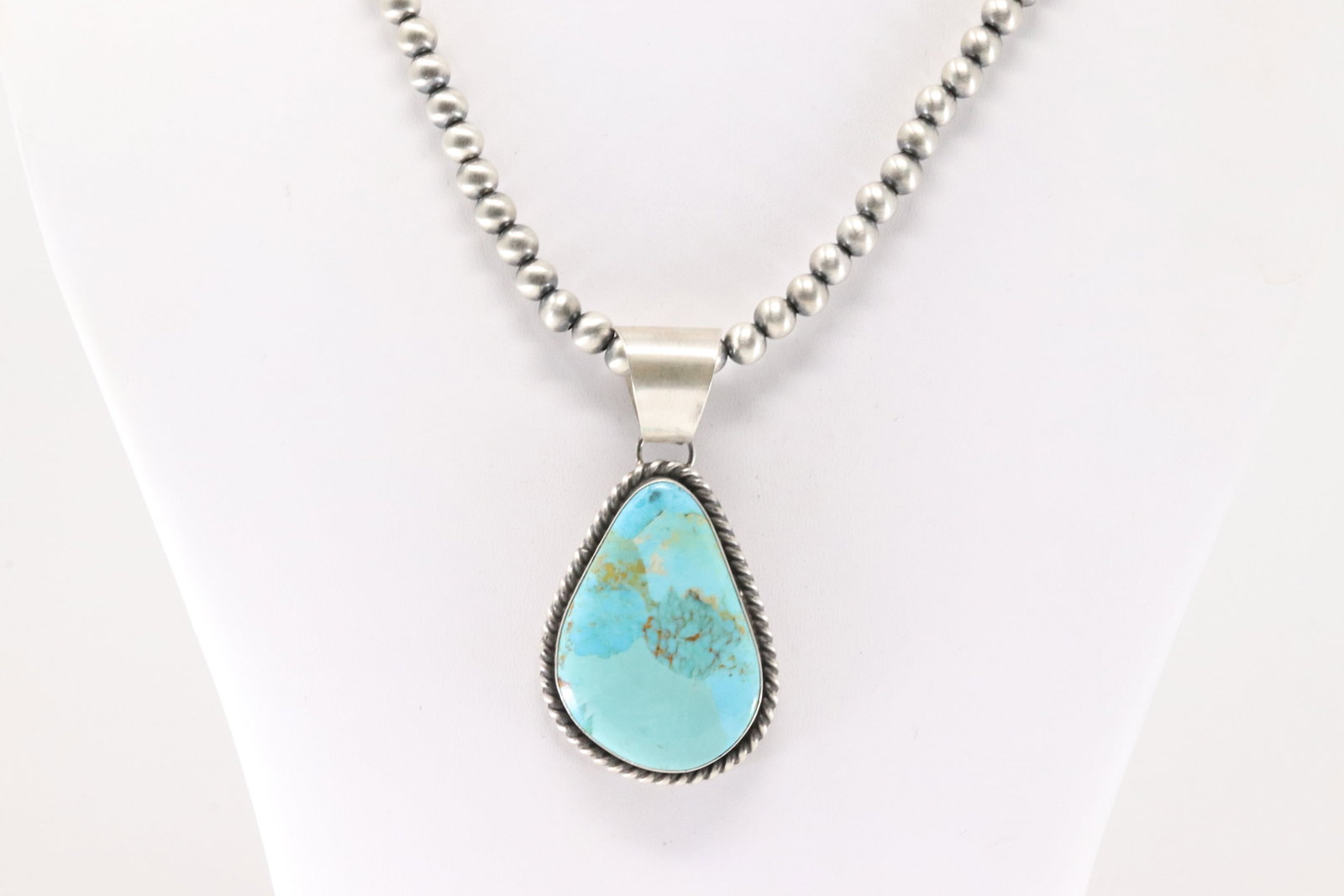 Native American Navajo Sterling Silver Kingman Turquoise Pendant By Donovan Skeets. With Sterling: This is a Native American Navajo Sterling Silver Kingman Turquoise Pendant By Donovan Skeets. With Sterling Silver Pearl Beaded Machine Made Necklace. Necklace length: 20.00"