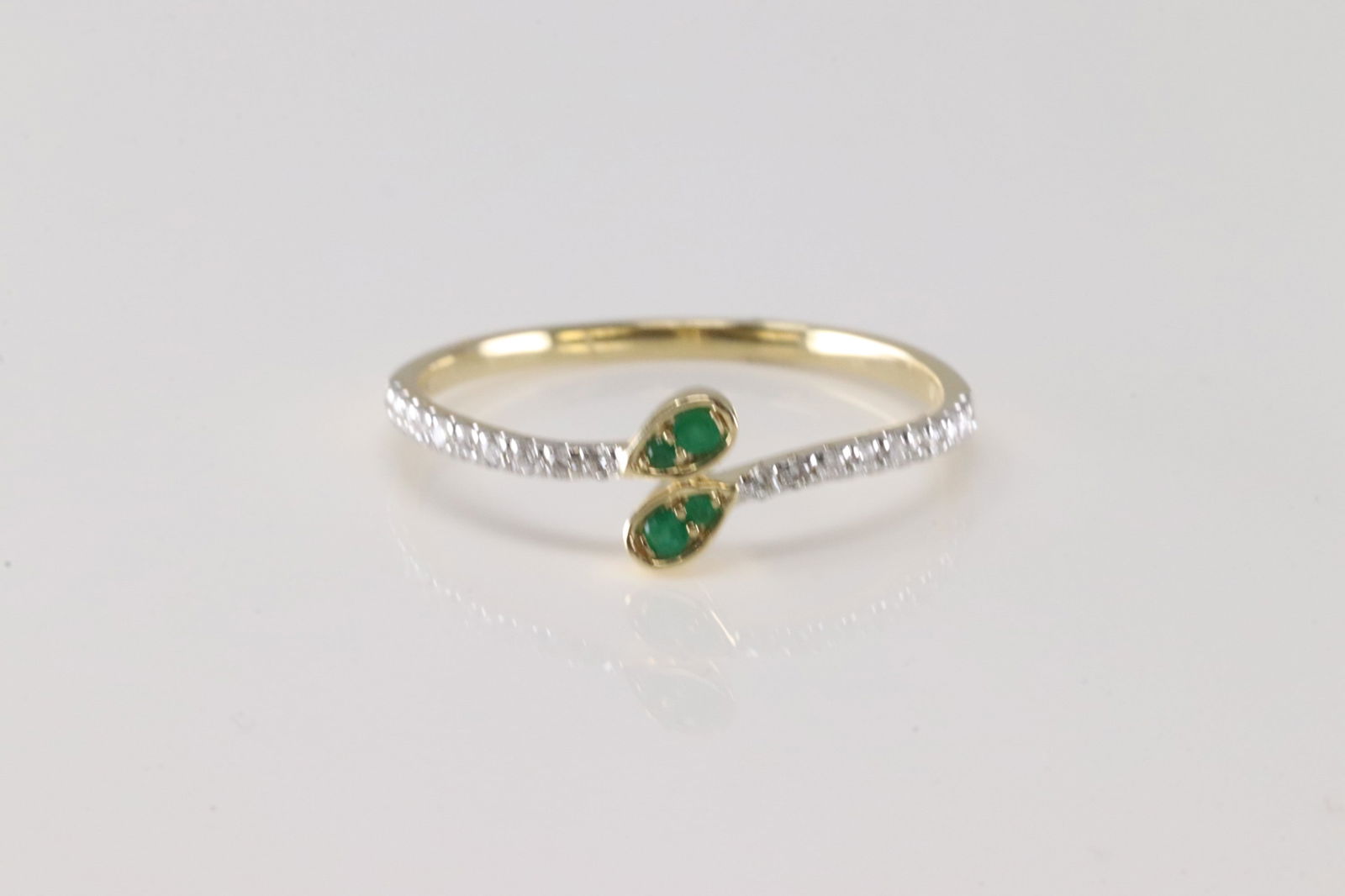 Emerald & Diamond Ring 14kt.: Ladies 14kt Yellow Gold Emerald & Diamond Ring. This Ring has 4 Beautiful Emerald Gems & Sparkling Diamonds On Each Side. Emerald Weight: 0.07 ctw. Diamond Weight: 0.12ctw. Ring Size: 7.00.
