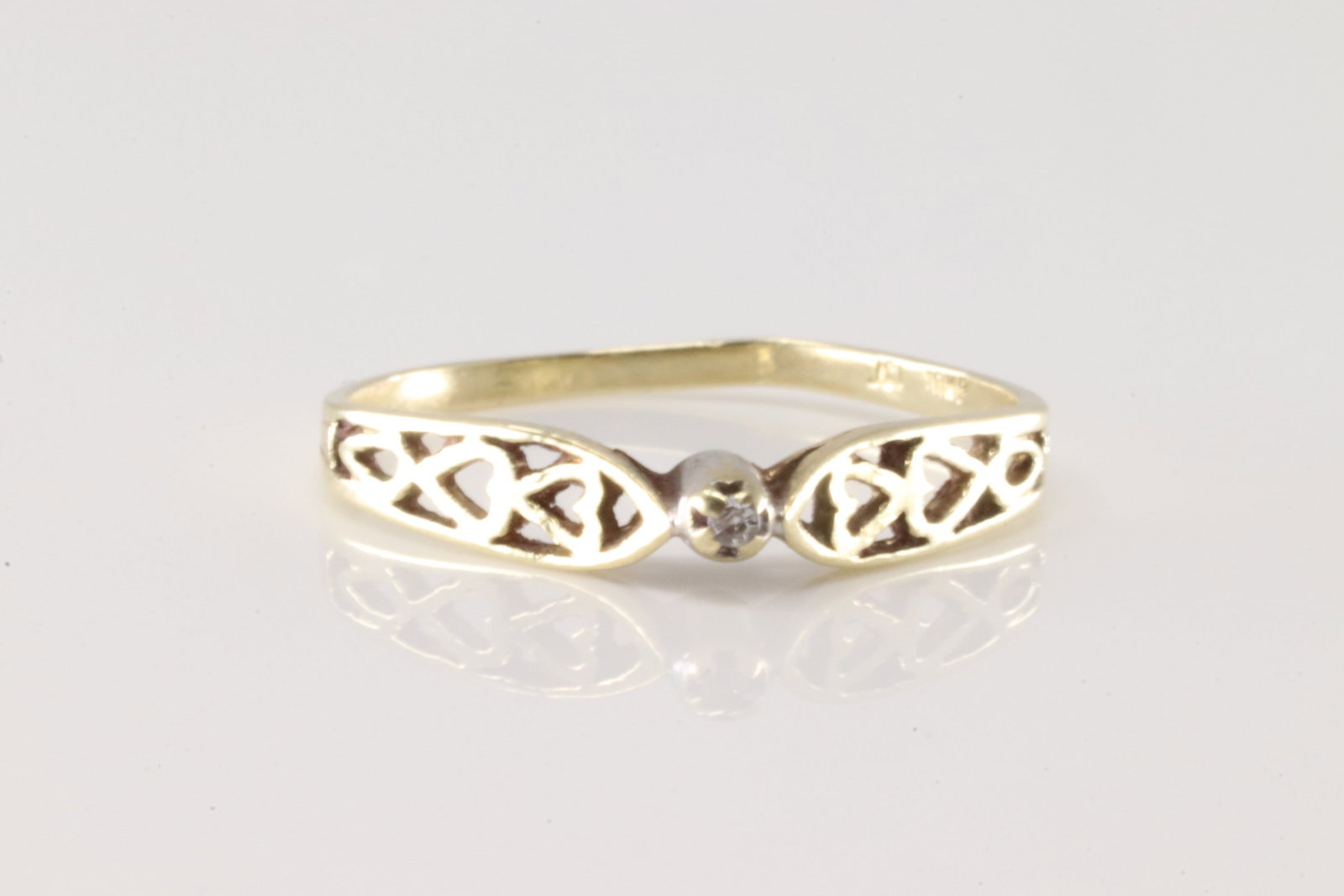 Diamond Ring 10Kt.: Ladies 10Kt Yellow Gold Diamodn Ring. This ring has hearts. Design with one smaller round diamond on the center. 6.25.