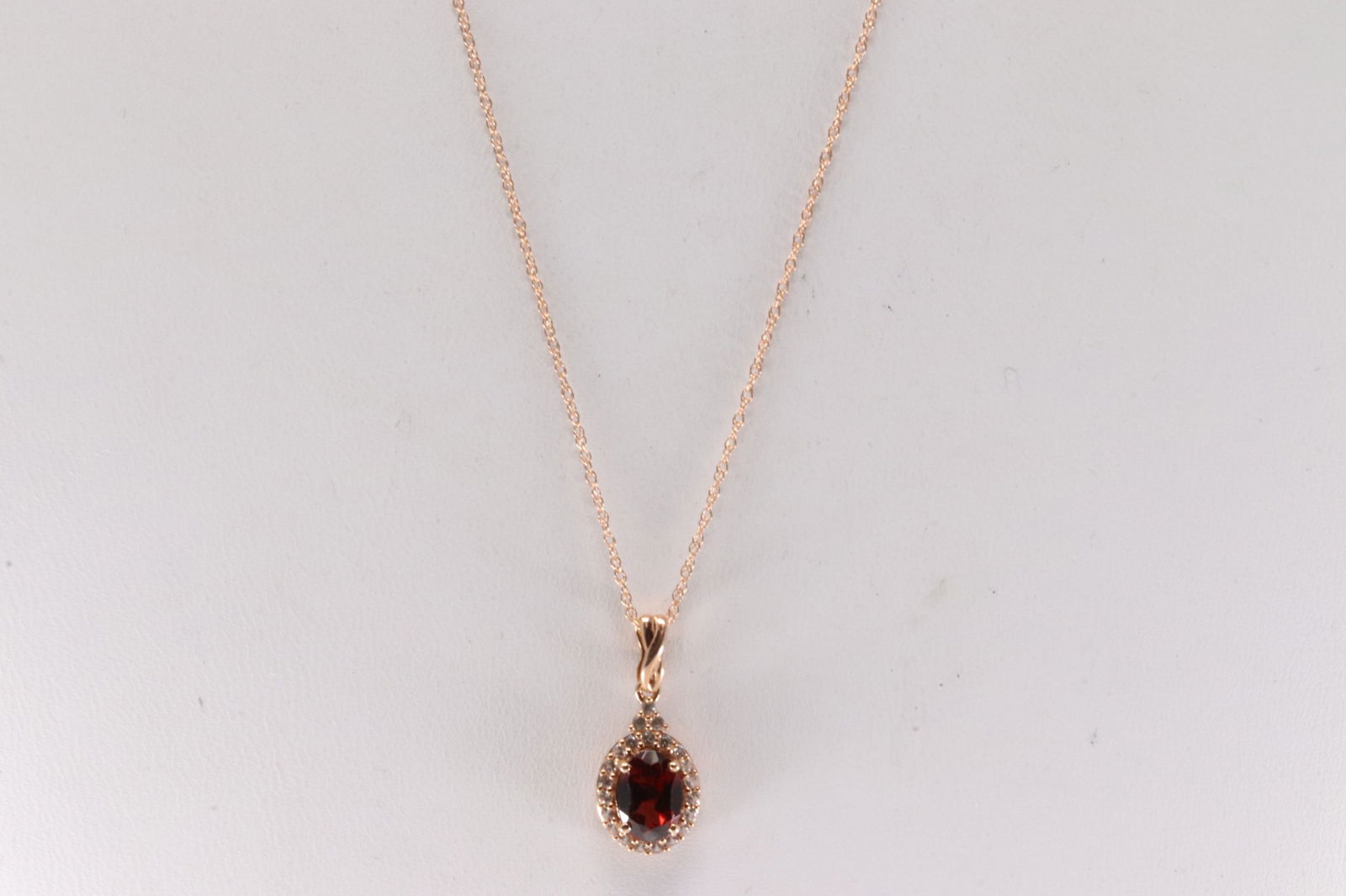 Garnet & White Sapphire Pendant / Necklace 10Kt.: Ladies 10Kt Rose Gold Garnet & White Sapphire Pendant / Necklace. This Charming Pendant has Garnet Gems with White Sapphire and A Necklace. Necklace length: 18.00"