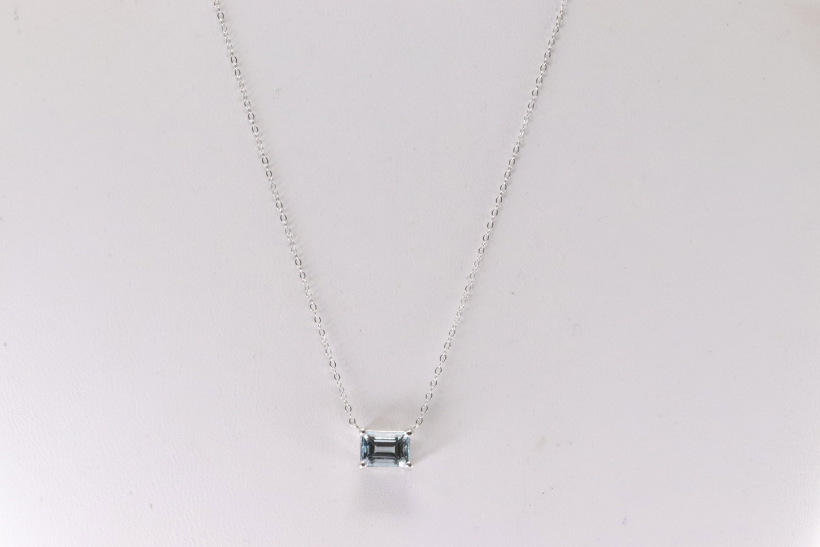 Aquamarine Necklace 14Kt.: Ladies 14Kt White Gold Aquamarine Necklace. This Necklace has an Charm with Blue Aquamarine Gems. Aquamarine weight: 0.99ct. Necklace length: 18.00"