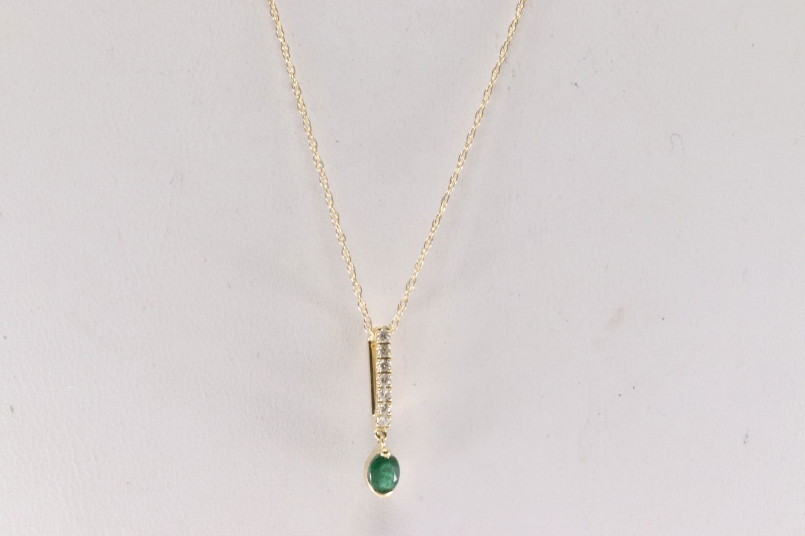 Emerald & Diamond Necklace 14Kt.: Ladies 14Kt Yellow Gold Emerald & Diamond Necklace. This Necklace has Pendant with Green Emerald and Sparkling Diamonds. Diamonds weight: 0.06ctw. Emerald weight: 0.16ct. Necklace length: 18.00"
