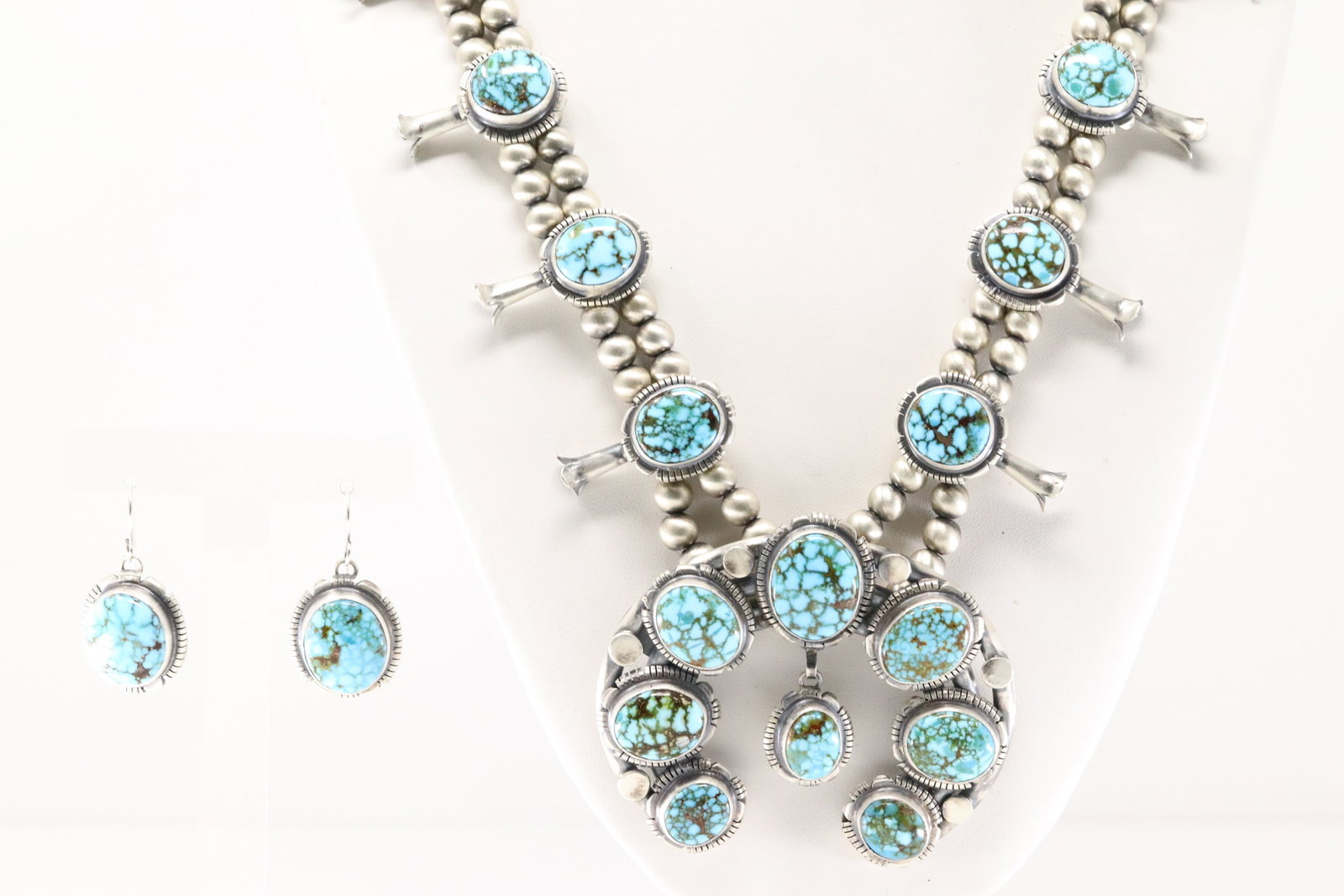 Native America Navajo Sterling Silver Kingman Turquoise Squash Blossom Necklace & Earring's Set By: This is a Native America Navajo Sterling Silver Kingman Turquoise Squash Blossom Necklace & Earring's Set By Thomas Francisco. Necklace length: 26.00" Total weight: 181.50 Grams.