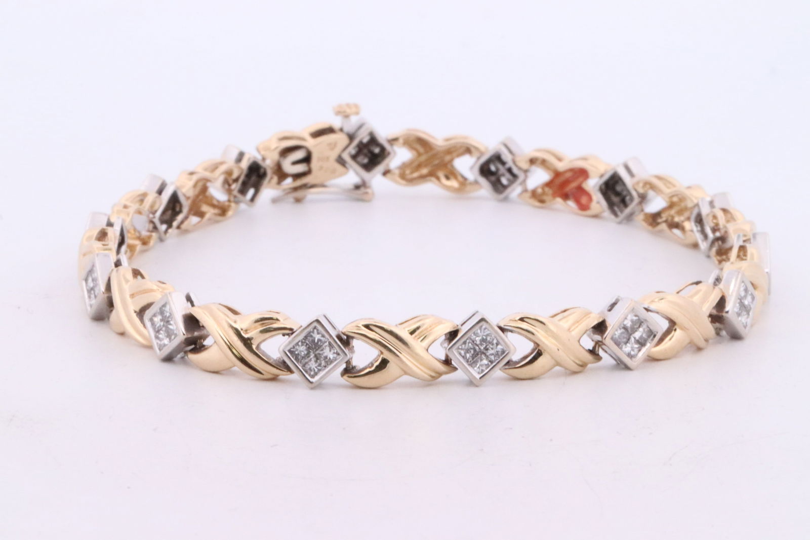 2ct Diamond Bracelet.: This is a 14kt two tone yellow gold bracelet. Diamonds Appx 2.00carats. 56 princess cut diomnds.Length 8in. Total weight 17.0 grams.