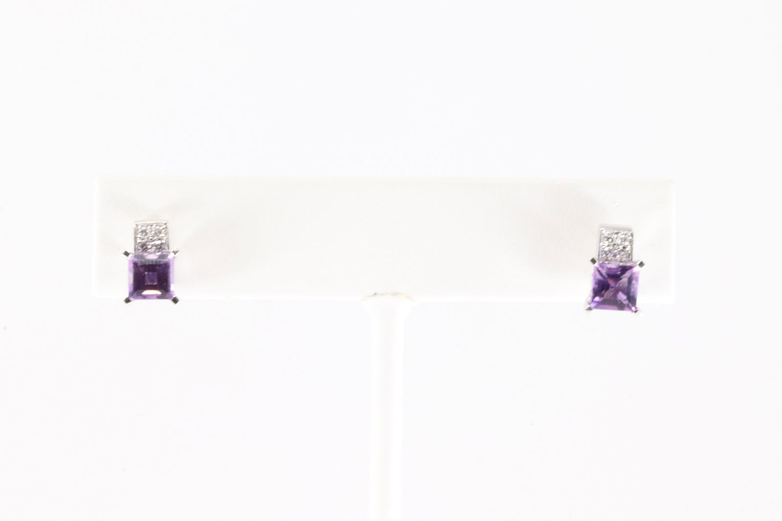 Amethyst & Diamond Stud Earring 18Kt.: 18Kt White Gold Amethyst & Diamond Stud Earring. This Elegant Stud Earring's has Purple Amethyst Gemstones with 8 Diamonds. Diamonds weight approx: 0.15ctw. Total weight: 3.00 Grams.