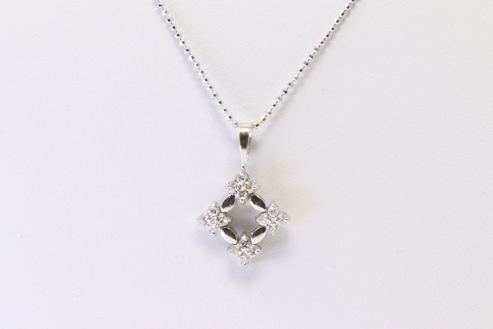 Diamond Pendant 18Kt.: Ladies 18Kt White Gold Diamond Pendant. Pendant has 16 round Diamonds with A 14k Necklace. Diamonds weight: approx 0.50ctw.Necklace length: 22.00" Total weight: 4.90 Grams.