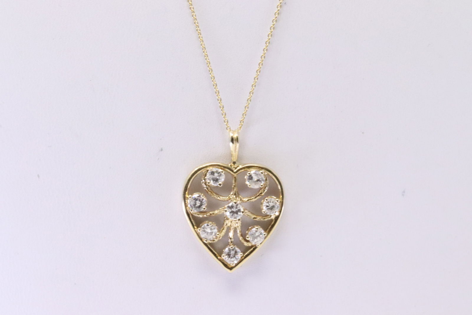 Diamond Heart Pendant 14k: Ladies 14Kt Yellow Gold Heart Diamond Pendant. Pendant has 8 round Diamonds with A 14K Necklace. Diamonds weight Approx: 1.00cttw.Necklace length: 18.00" Total weight: 4.70 Grams.
