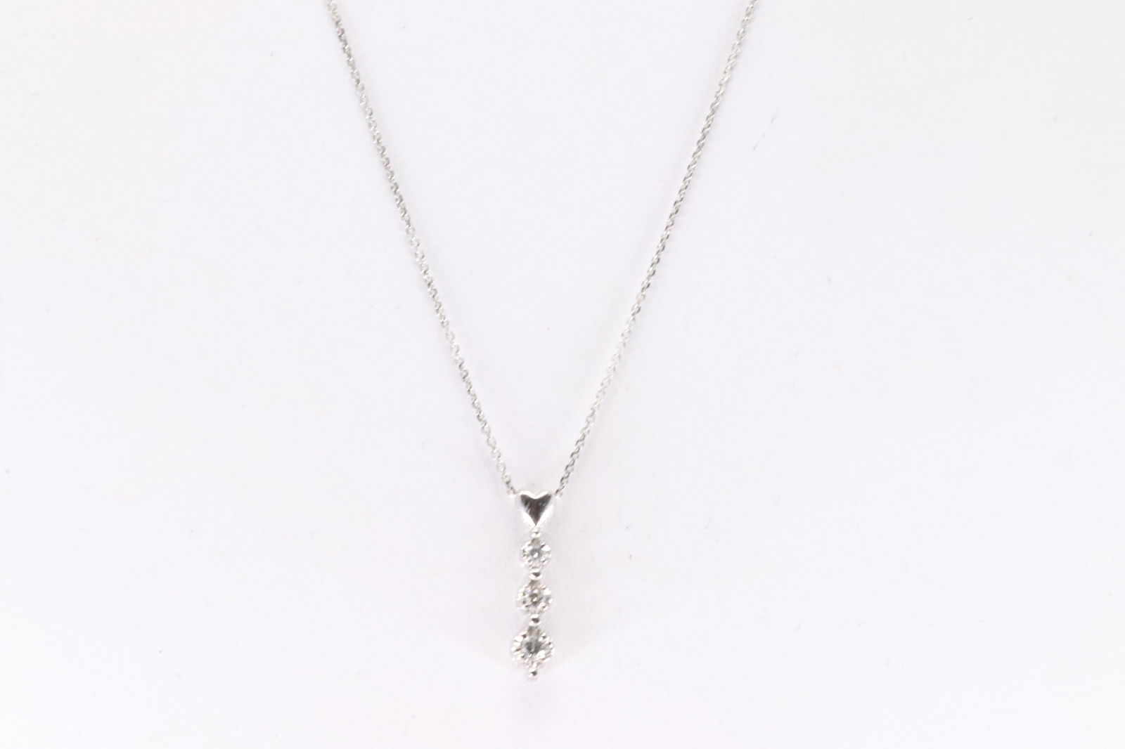 Diamond Pendant / Necklace 10Kt.: 10Kt White Gold Diamond Pendant / Necklace. This pendant has 3 round diamonds with a 14K white necklace. Diamonds weight approx: 0.10ctw. Necklace length: 16.00"
