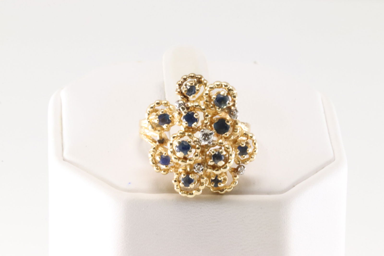 Sapphire & Diamond Ring 14Kt.: Ladies 14Kt Yellow Gold Sapphire & Diamond Ring. This beautiful has 5 sparkling diamonds with 11 round sapphire's. Ring size: 8.50. Total weight: 7.70 Grams.