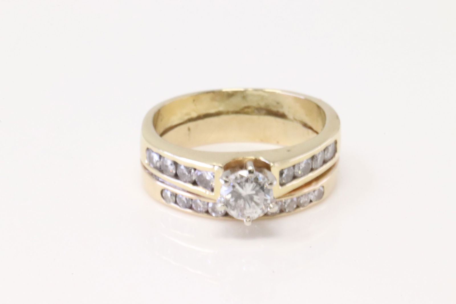 Double Band Diamond Ring 14Kt.: Ladies 14Kt Yellow Gold Double Band Diamond Ring. Ring has Engagement & Wedding Band With 19 round Diamonds. Side Diamonds weight approx:0.75 ctw center stone approx 0.50 ctw Ring size: 6.50. Total we