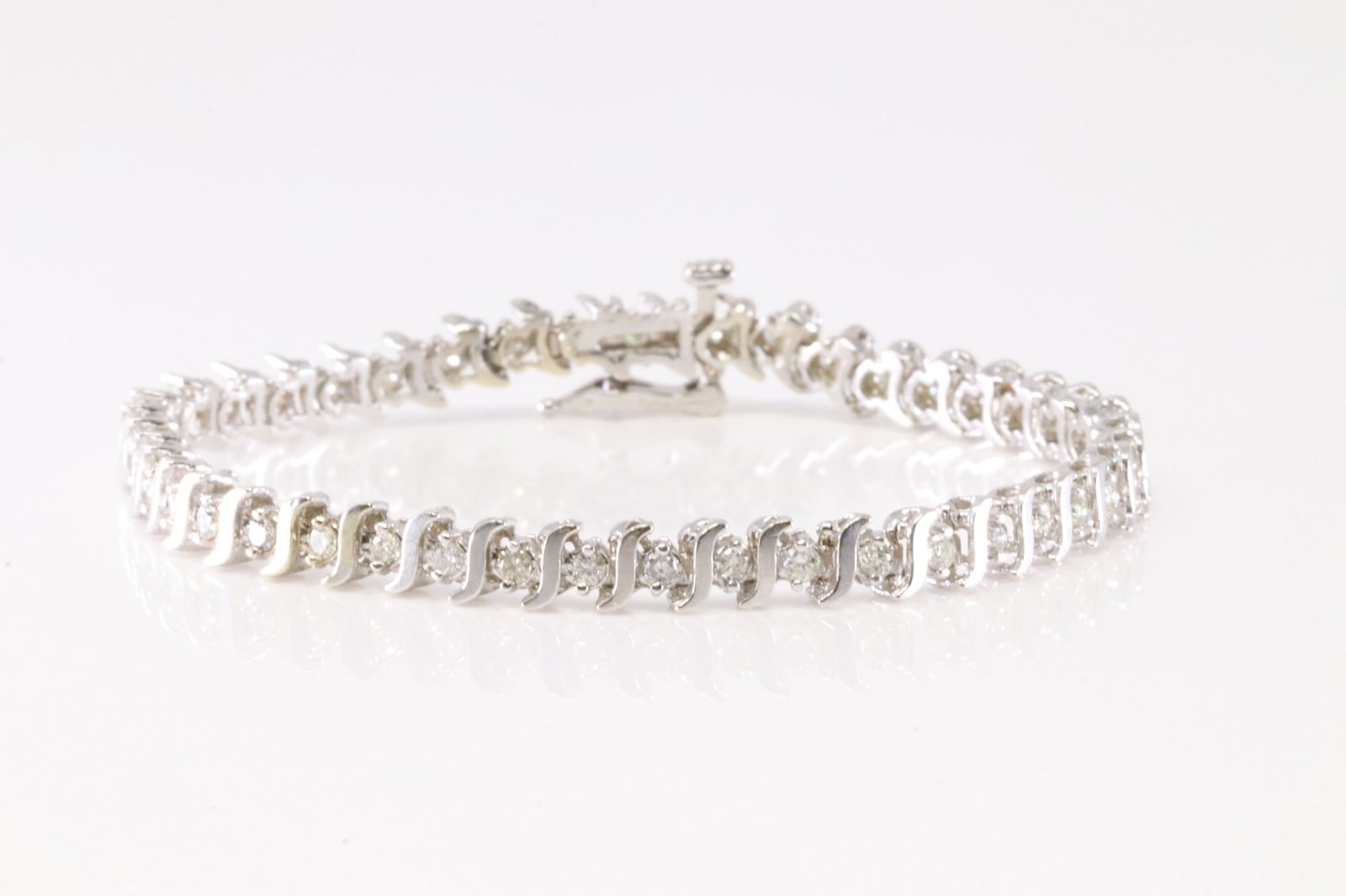 Diamond Bracelet 14Kt.: Ladies 14Kt White Gold Diamond Bracelet. This Charming Bracelet has 43 Round Sparkling Diamonds. Diamond Approx Weight: 2.00 ctw. Bracelet Length: 12.00. Total Weight: 7.53 Grams.