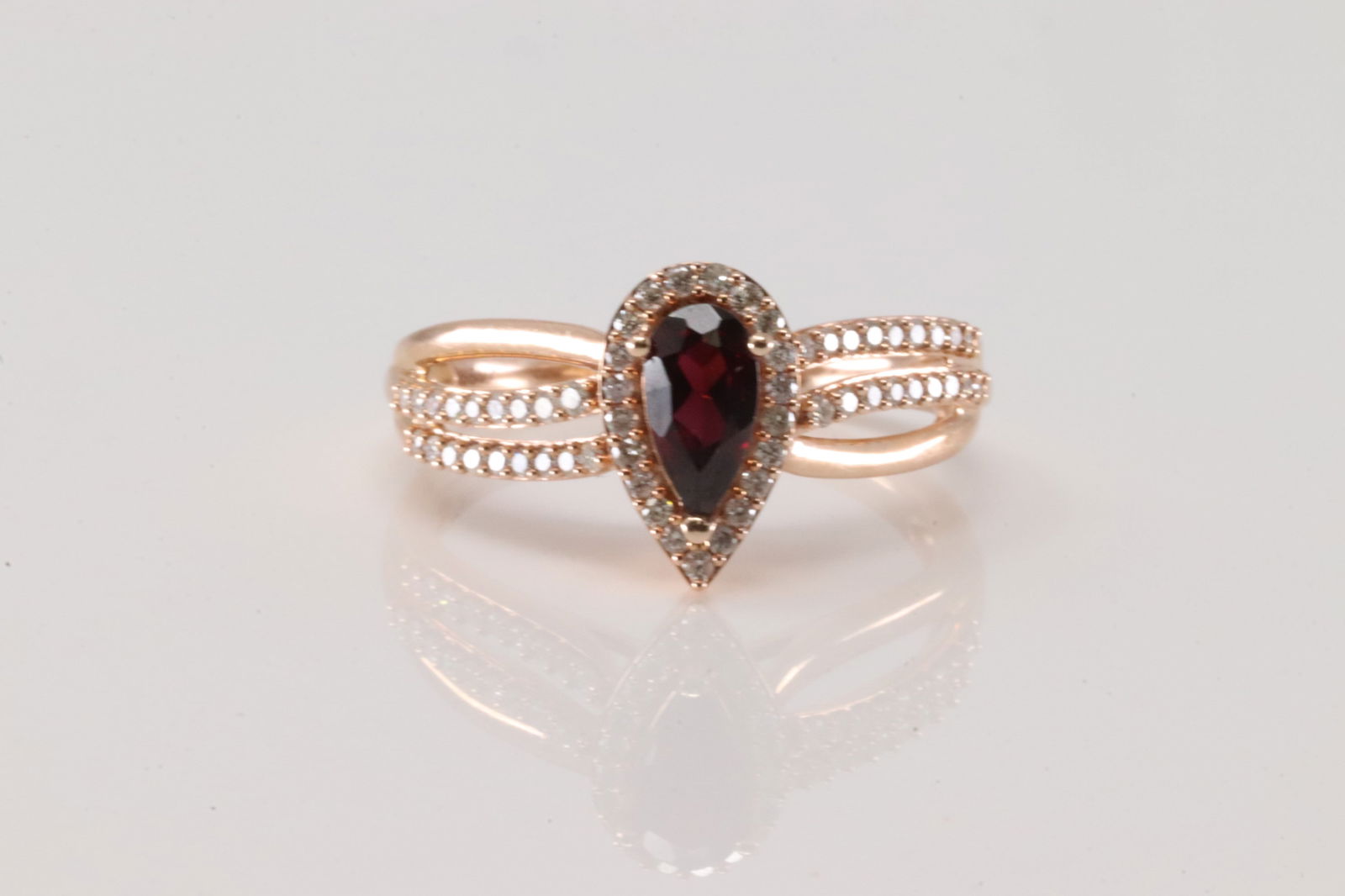 Garnet & Diamond Ring 10Kt.: Ladies 10Kt Rose Gold Garnet & Diamond Ring. This Ring has Tear-Drop Garnet with Sparkling round Diamonds. Diamonds weight: 0.40ctw. Ring size: 8.00. Total weight: 3.40 Grams.