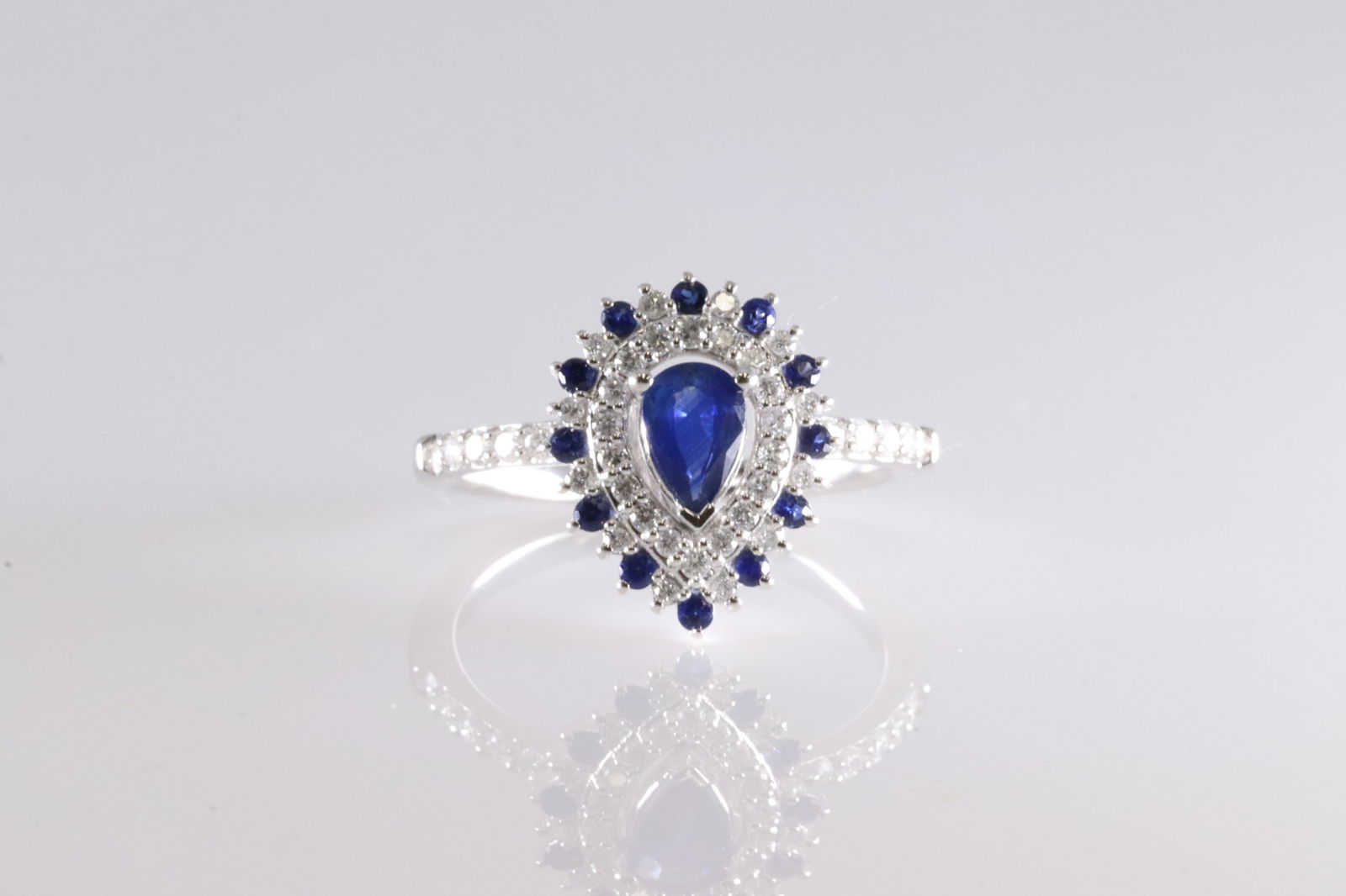 Sapphire & Diamond Ring 14kt.: Ladies 14kt White Gold Sapphire & Diamond Ring. Pear Cut Desing With 16 Blue Sapphire Gems & 40 Round Sparkling Diamonds. Sapphire Weight: 0.58ctw. Diamond Weight: 0.33ctw Ring Size: 6.50.