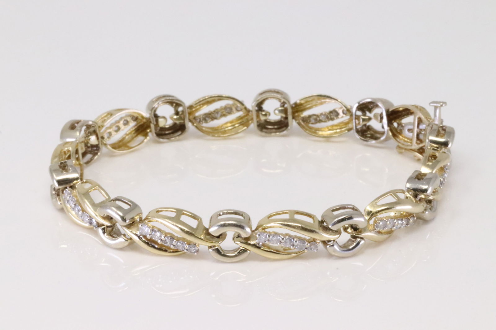 Diamond Bracelet 14Kt.: Ladies 14Kt Yellow Gold Diamond Bracelet. Bracelet has 2 tone with 50 round Diamonds. Diamonds weight: 1.50cttw. Bracelet length: 7.50" Total weight: 15.60 Grams.