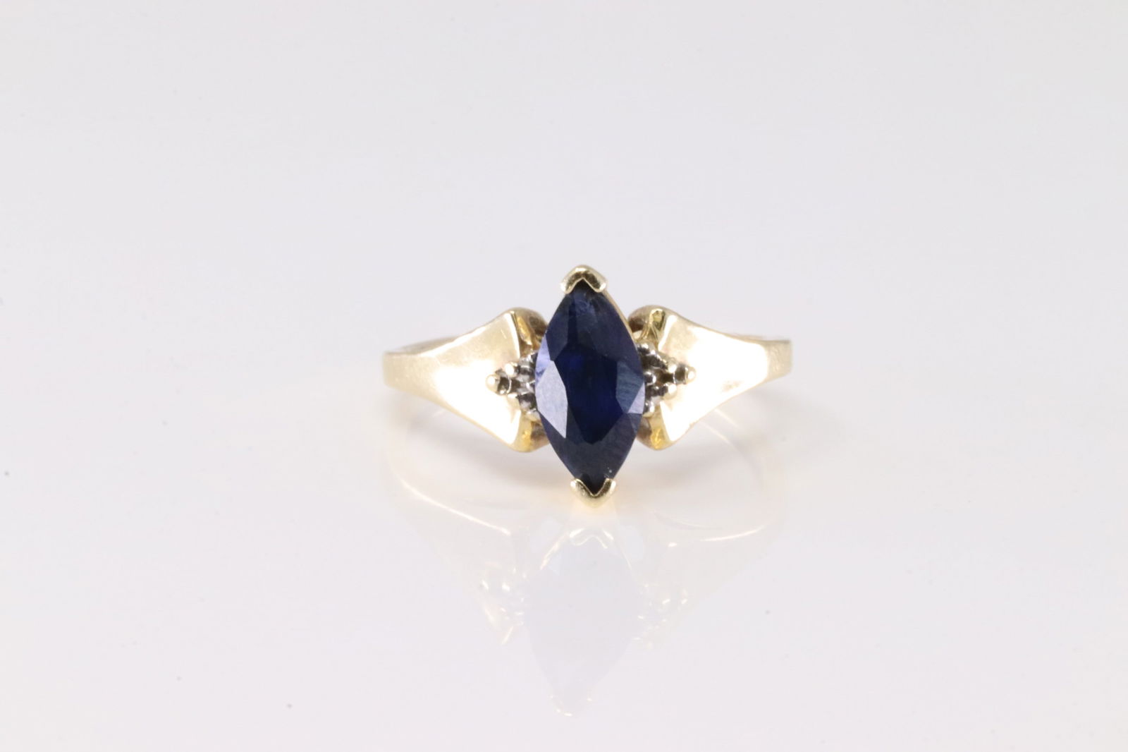 Sapphire & Diamond Ring 10Kt .: Ladies 10Kt Yellow Gold Sapphire & Diamond. This Chraming Ring has Marquise Sapphire with 2 Sparkling Diamonds. Ring size: 6.00. Total weight: 2.38 Grams.