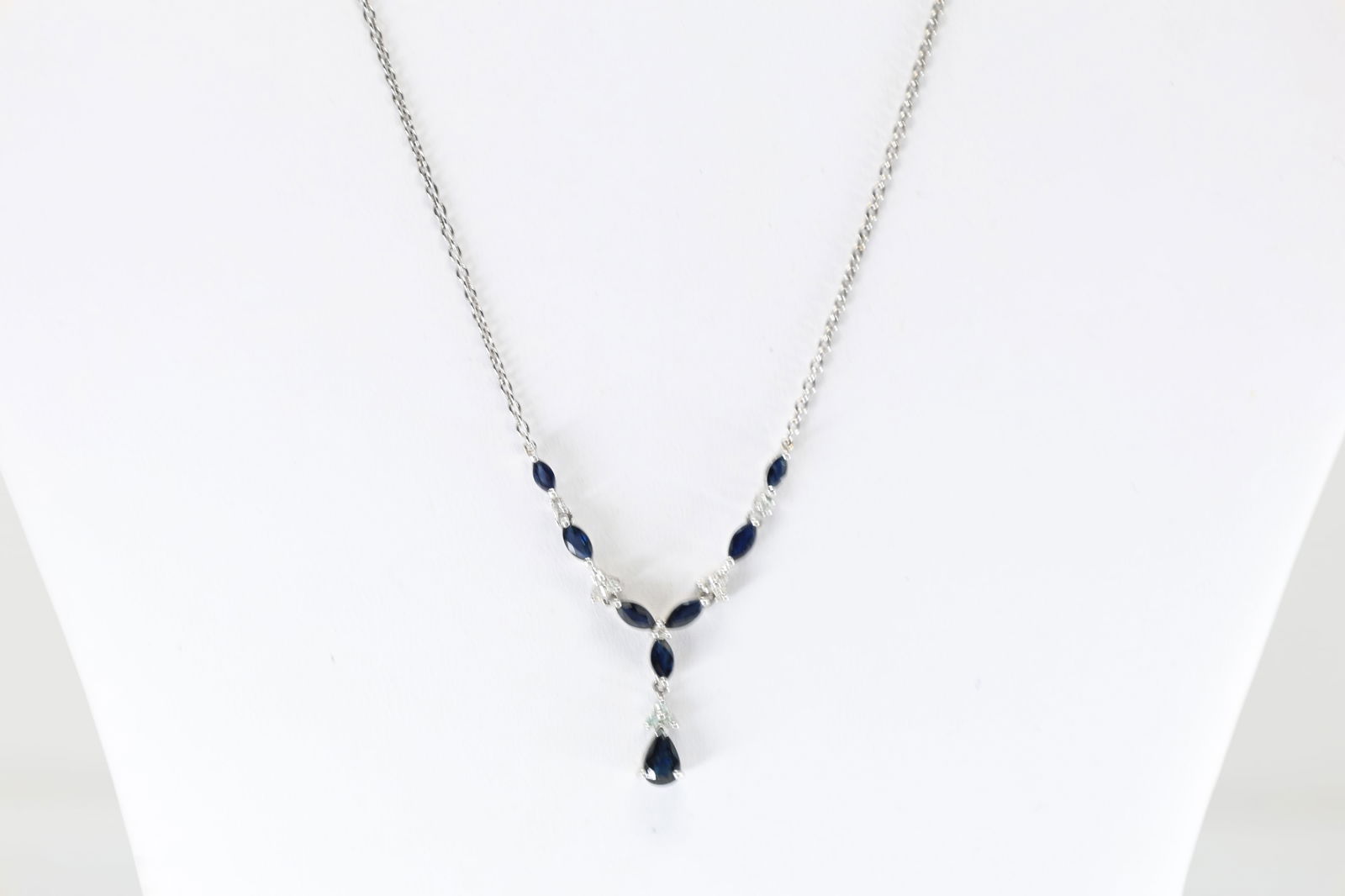 Sapphire & Diamond Necklace 14Kt.: Ladies 14Kt White Gold Sapphire & Diamond Necklace. This gorgeous necklace with an floral pendant. adornment is crafted in white gold and set with 11 smaller diamonds and marquise / pear-shape