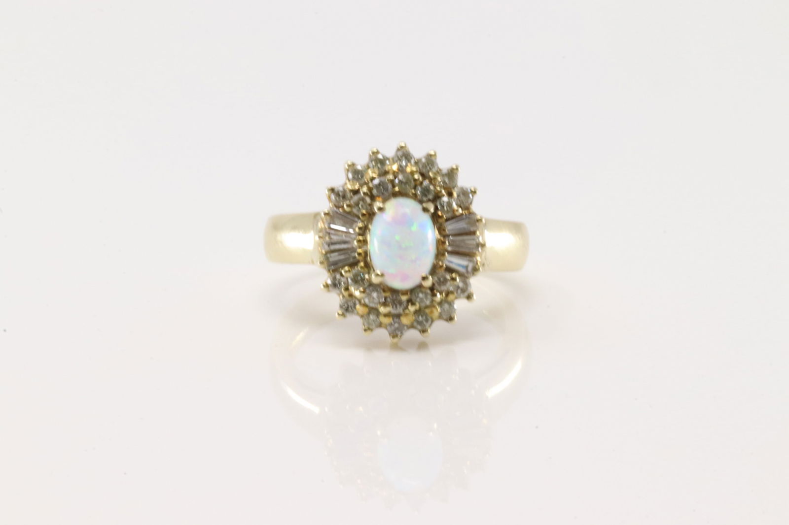 Opal & Baguette Diamond Ring 14Kt.: Ladies 14Kt Yellow Gold Opal & Baguette Diamodn Ring. This elegant ring has white oval opal with 30 baguette & round diamonds. Diamonds weight approx: 0.60 ctw Ring size: 7.50. Total weight: 7.00