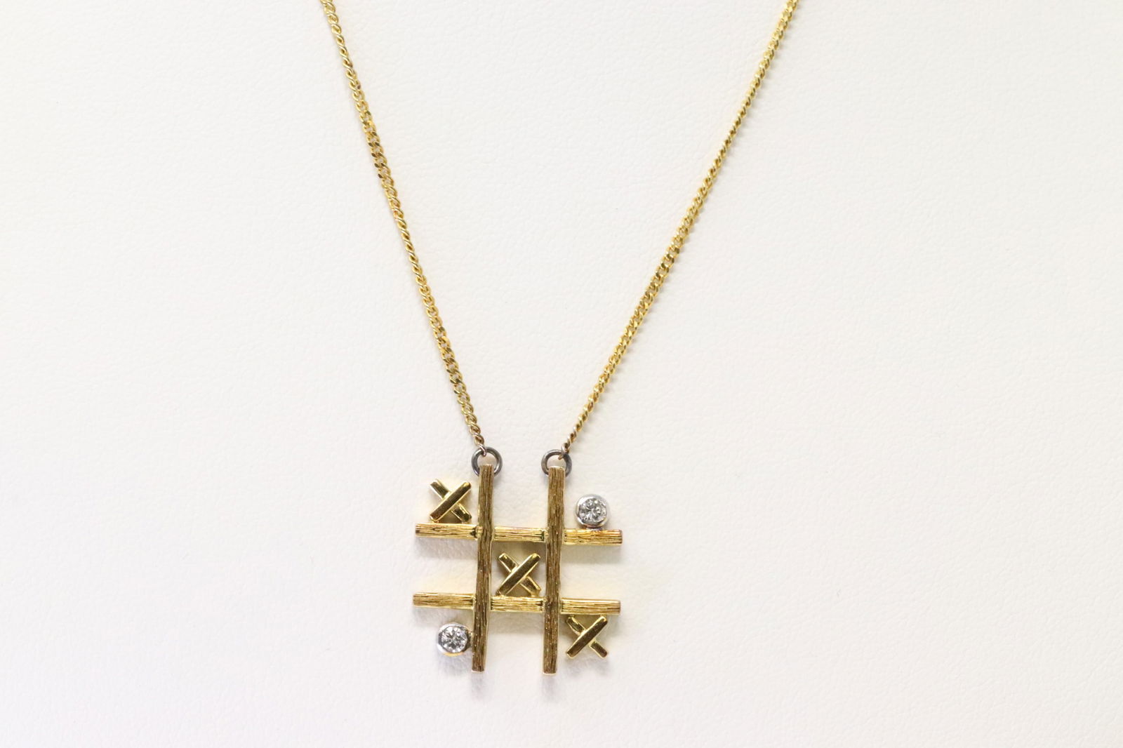 Diamond Necklace 14Kt.: 14Kt Yellow Gold Diamond Necklace. Necklace has Pendant with X & 2 Diamonds. Necklace length: 14.00" Total weight: 6.50 Grams.