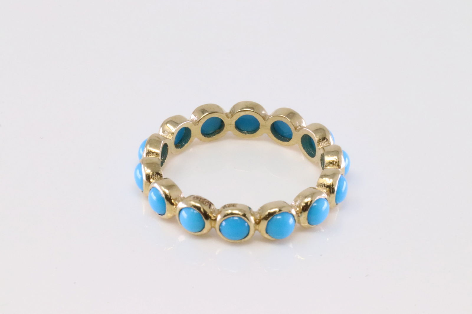 Eternity Turquoise Ring 18Kt.: Ladies 18Kt Yellow Gold Eternity Turquoise Ring. Ring has 14 round Turquoise. Ring size: 7.00. Total weight: 3.00 Grams.