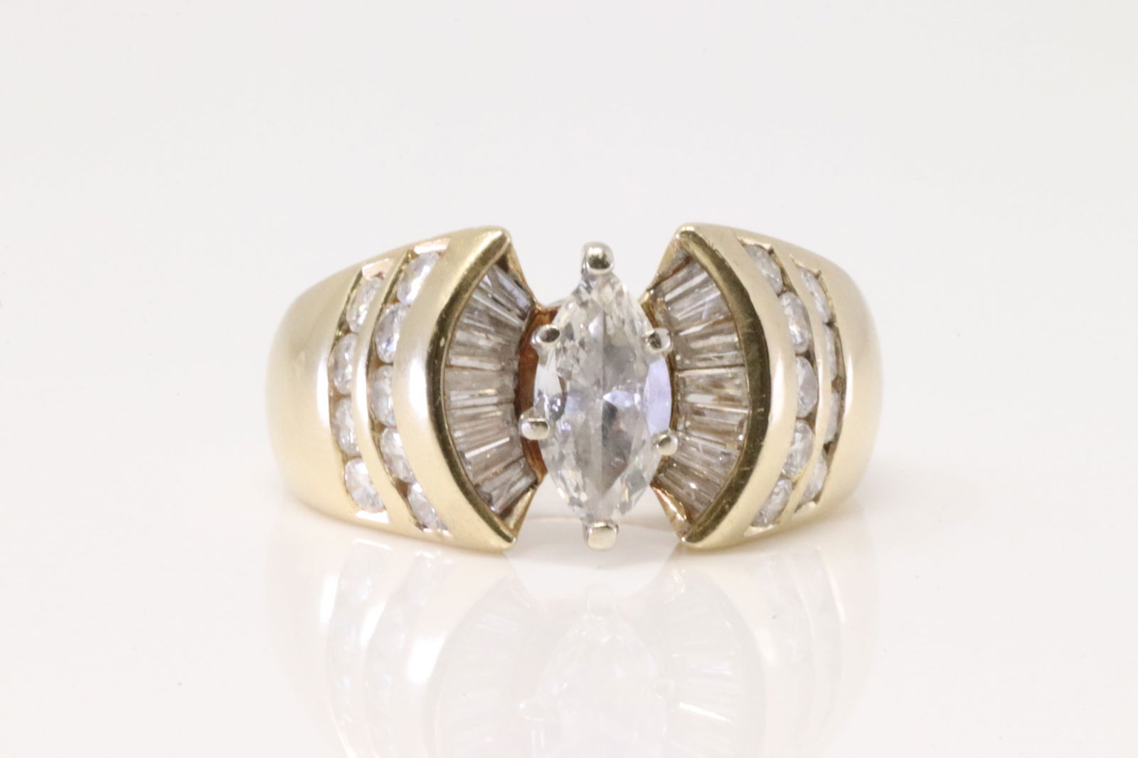 Diamond Ring 14Kt.: Ladies 14Kt Yellow Gold Diamond Ring. Ring has a Marquise set on the center weighing approx 1.00ct, with 14 Baguette cut Diamonds & 18 round Diamonds. Diamonds approx weight: 2.50ctw.Ring size: