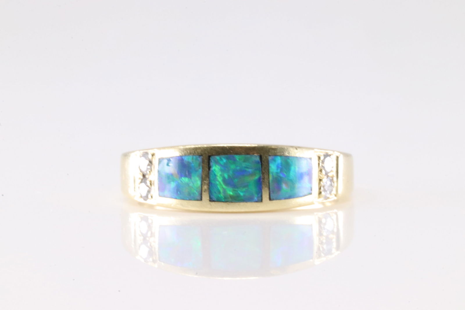 Blue Opal & Diamond Ring 14Kt.: Ladies 14Kt Yellow Gold Blue Opal & Diamond Ring. This Elegant Ring has Blue Opal Gemstones With 4 Round Sparkling Diamonds. Ring Size: 7.50. Total Weight: 4.78 Grams.