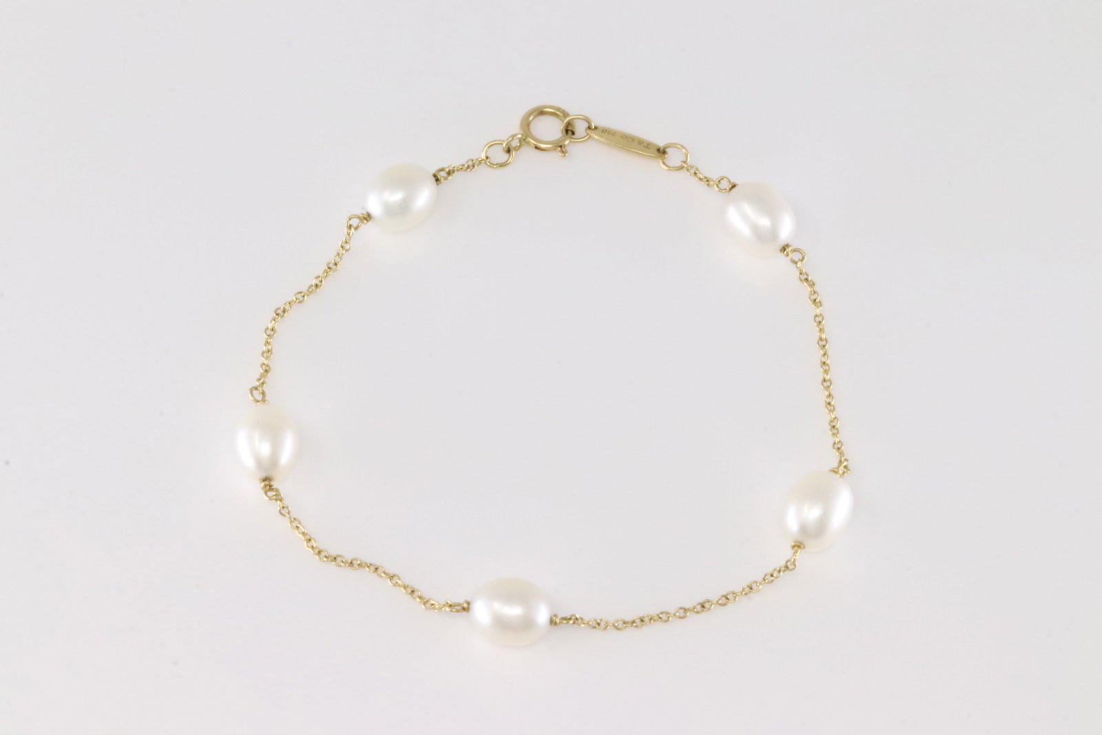 Tiffany & Co Pearl By The Yard Bracelet 18Kt.: Tiffany & Co 18Kt Yellow Gold Pearl By The Yard Bracelet. This Charming Bracelet has Five Freshwater Cultured Pearls. Bracelet length: 8.00. Total weight: 3.00 Grams.
