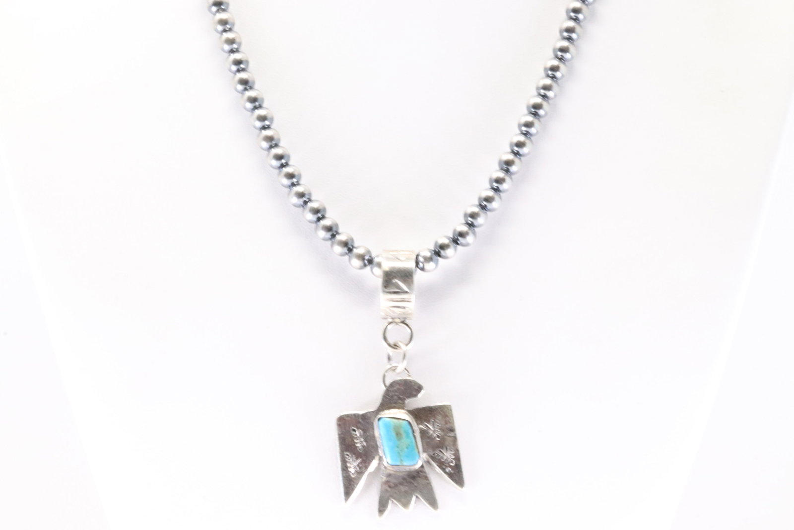 Native America Navajo Sterling Silver Kingman Turquoise Thunderbird Pendant By Jude Candelaria. With: This is a Native America Navajo Sterling Silver Kingman Turquoise Thunderbird Pendant By Jude Candelaria. With Pearl Beaded Sterling Silver Machine Made Necklace. Neckalce length: 16.00"