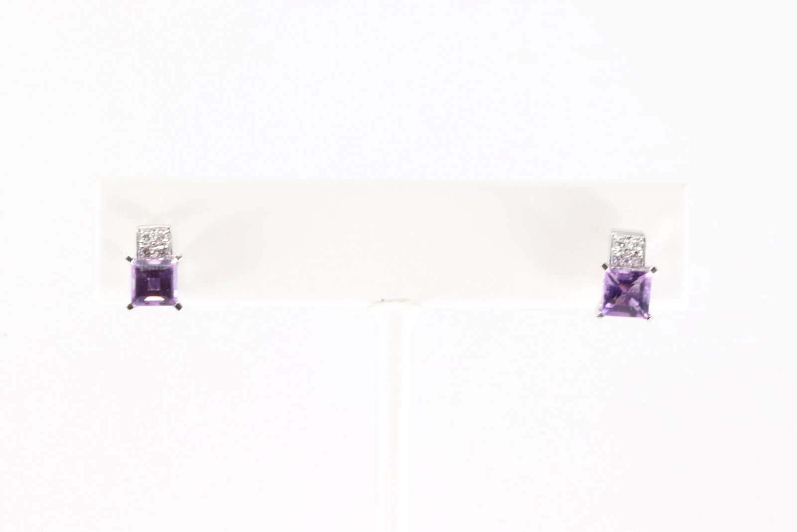 Amethyst & Diamond Stud Earring 18Kt.: 18Kt White Gold Amethyst & Diamond Stud Earring. This Elegant Stud Earring's has Purple Amethyst Gemstones with 8 Diamonds. Diamonds weight approx: 0.15ctw. Total weight: 3.00 Grams.