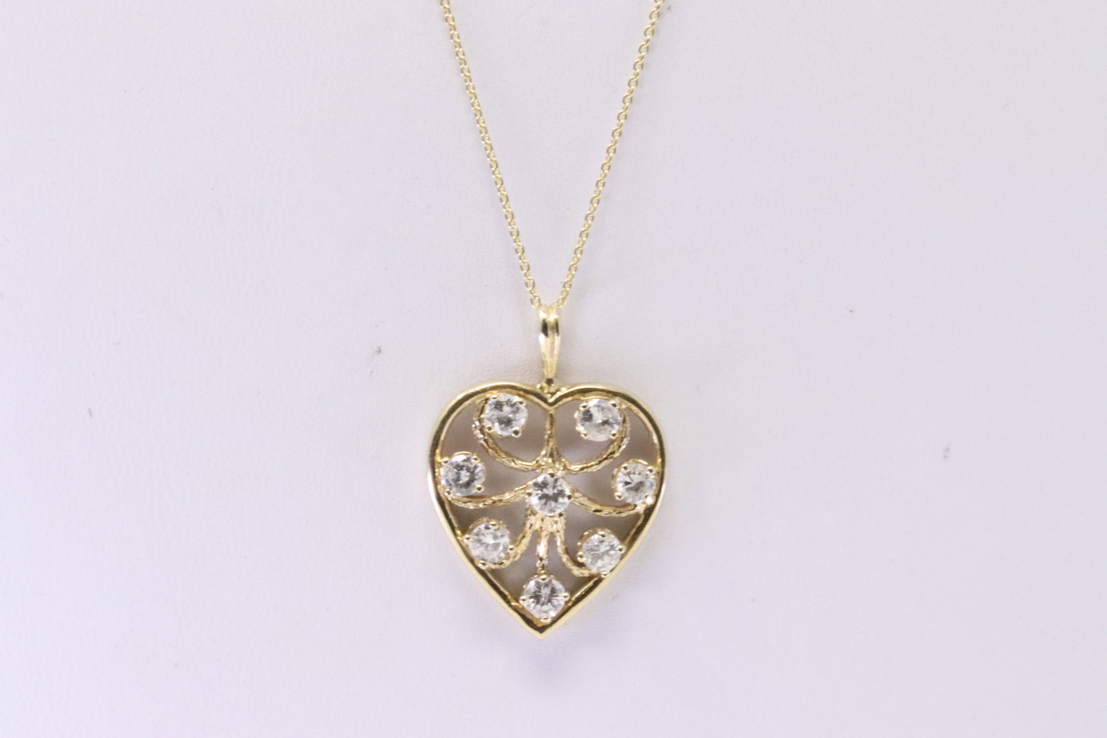 Diamond Heart Pendant 14k: Ladies 14Kt Yellow Gold Heart Diamond Pendant. Pendant has 8 round Diamonds with A 14K Necklace. Diamonds weight Approx: 1.00cttw.Necklace length: 18.00" Total weight: 4.70 Grams.