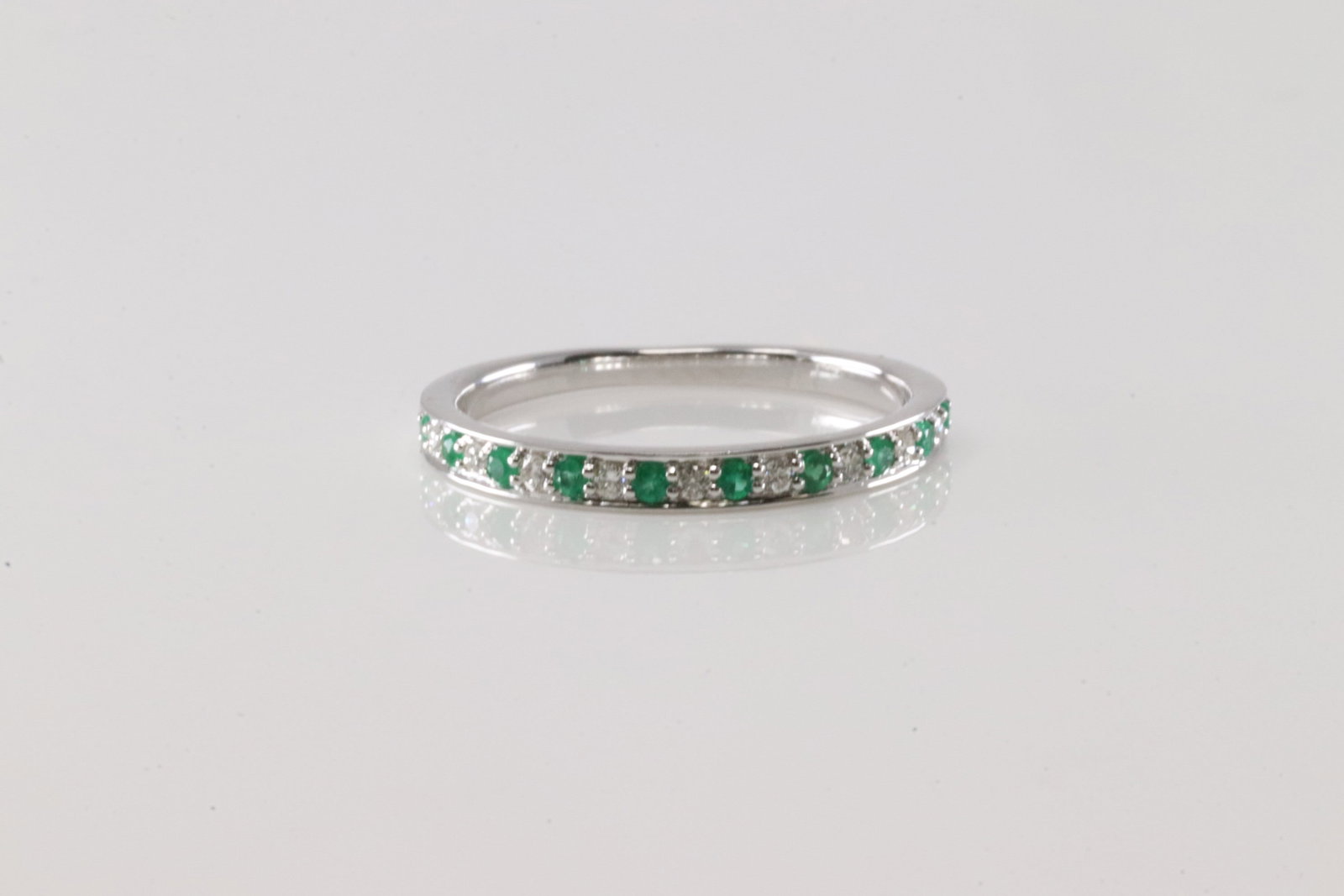 Emerald & Diamond Ring 14Kt.: Ladies 14Kt White Gold Emerald & Diamond Ring. This Ring has 10 Green emeralds with 9 round Diamonds. Diamonds weight: 0.09ctw. Emeralds weight: 0.10ctw. Ring size: 6.25.
