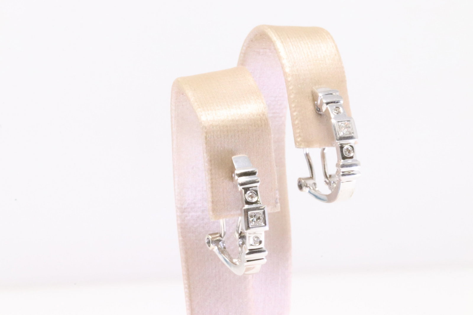 Diamond Huggie Earring 14Kt.: Ladies 14Kt White Gold Diamond Huggie Earring. Earring's has 4 round & 2 Cut Square Diamonds With French Backing Style. Diamonds weight approx: 0.20ctw. Total weight: 4.20 Grams.