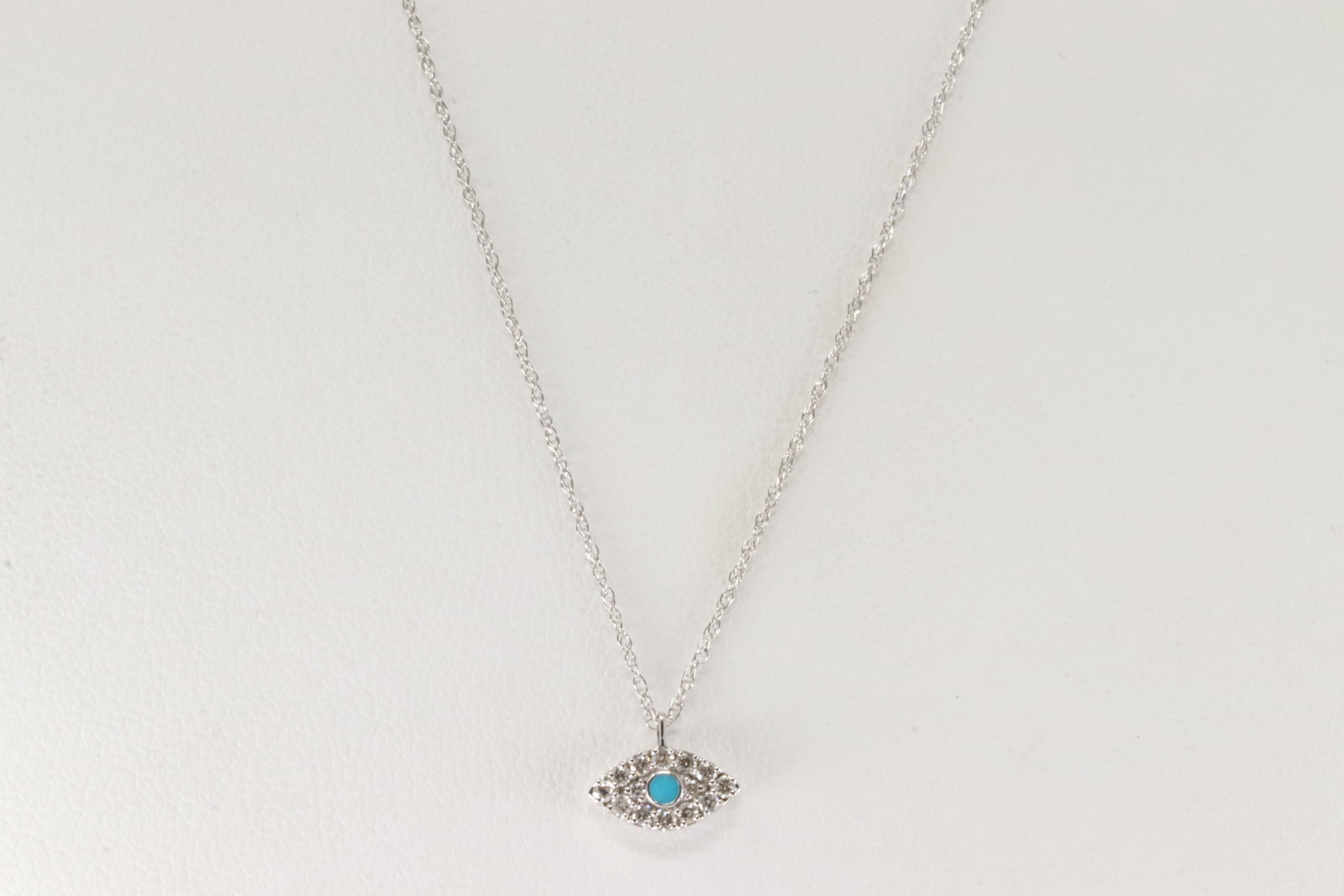 Turquoise & Diamond Eye Evil Pendant / Necklace 14Kt.: 14Kt White Gold Turquoise / Diamond Eye Evil Pendant and Necklace. This Necklace has Eye Evil Pendant with blue Turquoise and 14 Sparkling Diamonds. Diamonds weight: 0.14ctw. Necklace length: 18.00"