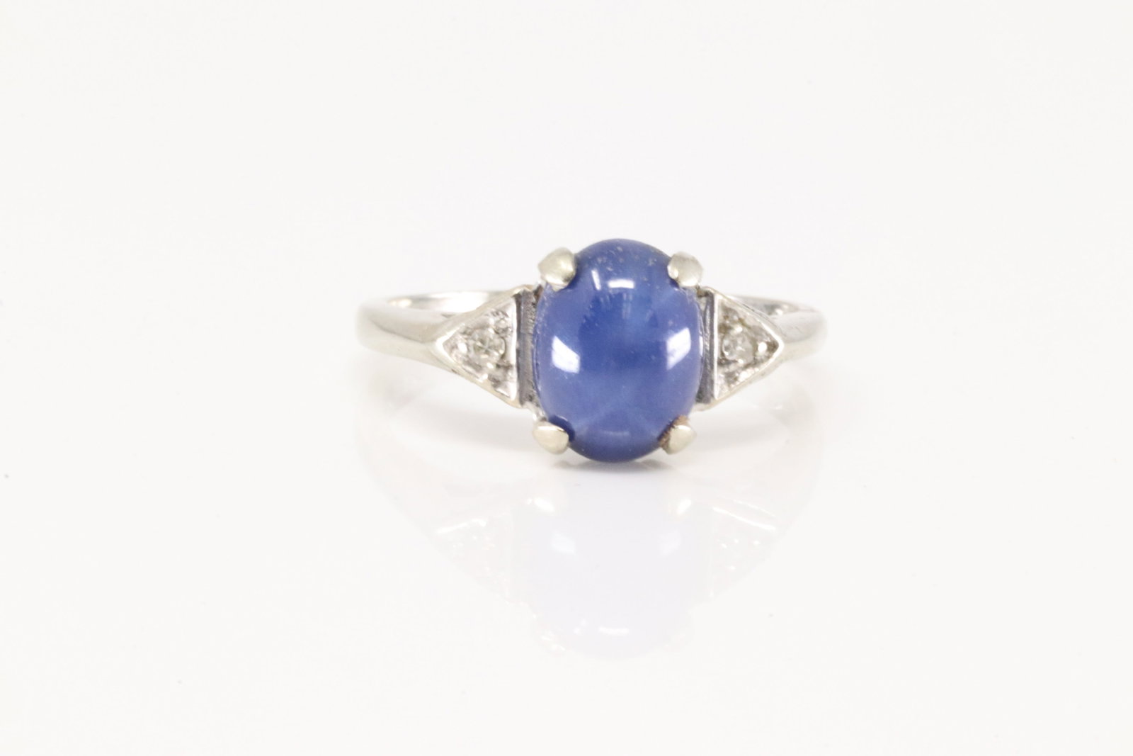 Cabochon Sapphire & Diamond Ring 14Kt.: 14Kt White Gold Cabochon Sapphire & Diamond Ring. This ring has beautiful blue cabochon sapphire with 2 round diamonds. Ring size: 6.25. Total weight: 3.00 Grams.