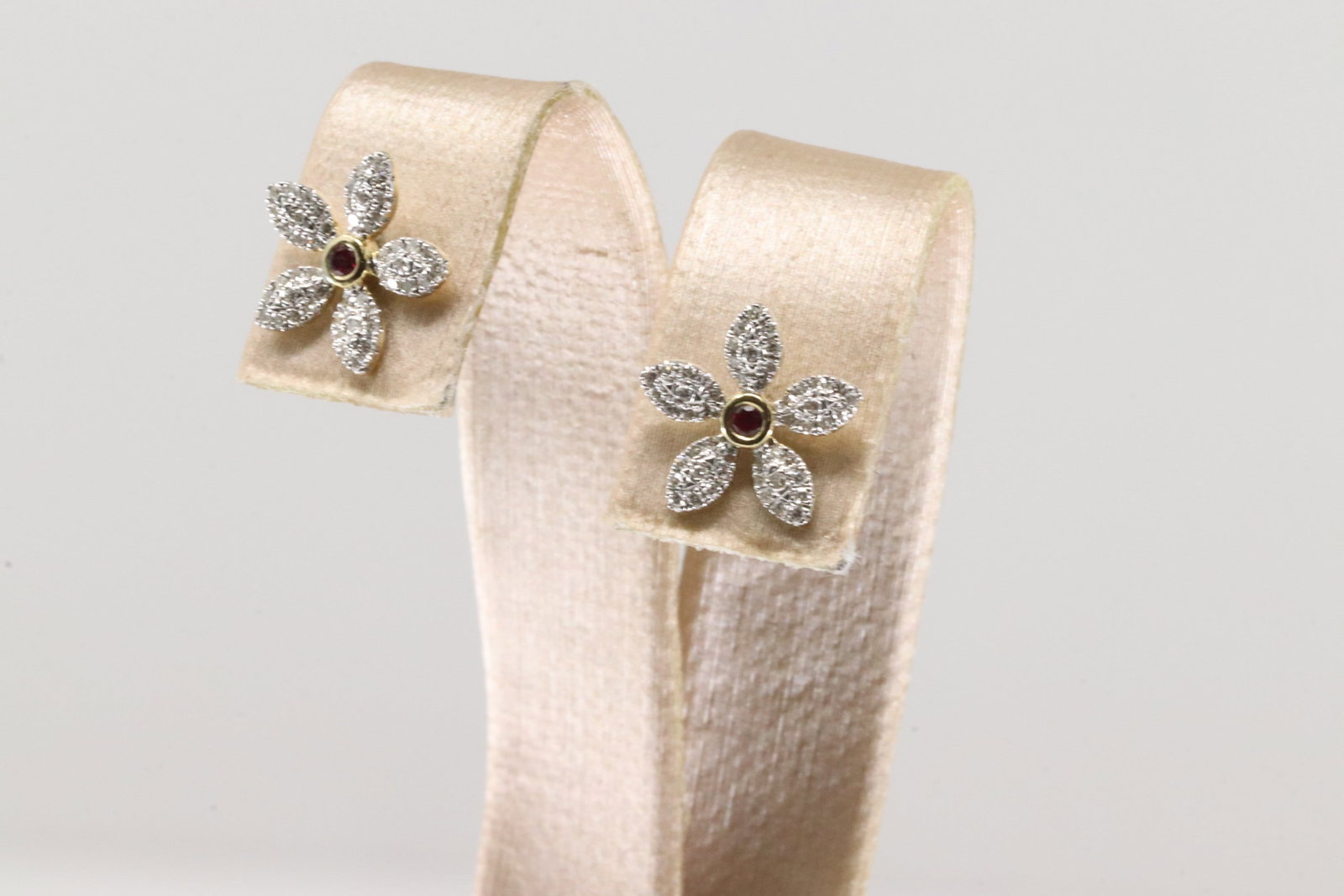 Ruby & Diamond Stud Earring 10Kt.: Ladies 10Kt Yellow Gold Ruby & Diamond Stud Earring. This Earring's Has Beautiful Flower Desing With Sparkling Diamonds & Gorgeous Ruby Gem In The Center. Diamond Weight: 0.25ctw.