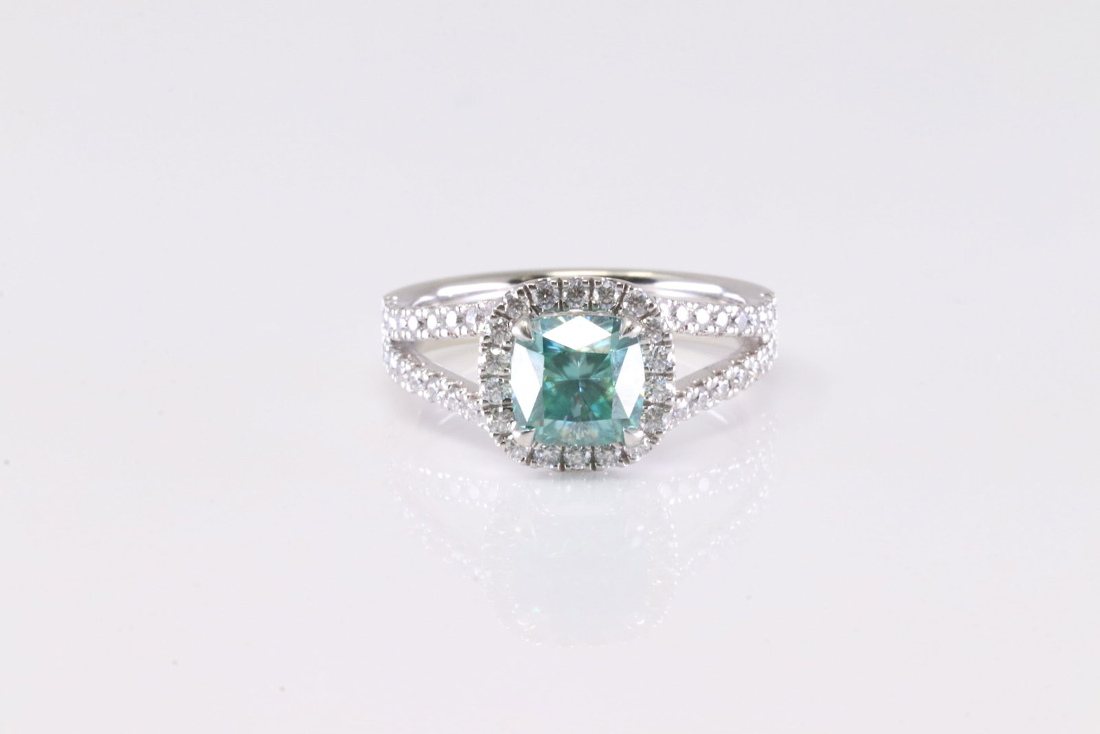 Blue Diamond Ring 14Kt.: Ladies 14Kt White Gold Blue Diamond Ring. This Elegant Ring has Blue Diamond center Surrende By White Sparkling Diamonds. Diamonds weight approx: 2.00cttw. 6.75. Total weight: 4.30 Grams.