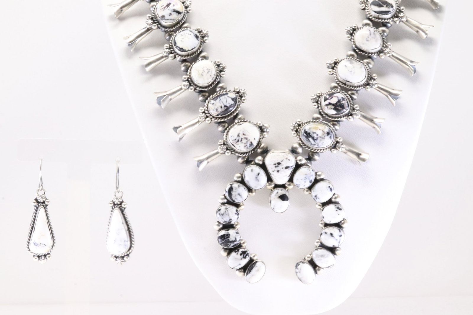 Native America Navajo Sterling Silver White Buffalo Squash Blossom Necklace & Earring's Set By: This is a Native America Navajo Sterling Silver White Buffalo Squash Blossom Necklace & Earring's Set By T.Smith. Necklace length: 20.00" Total weight: 148.35 Grams.