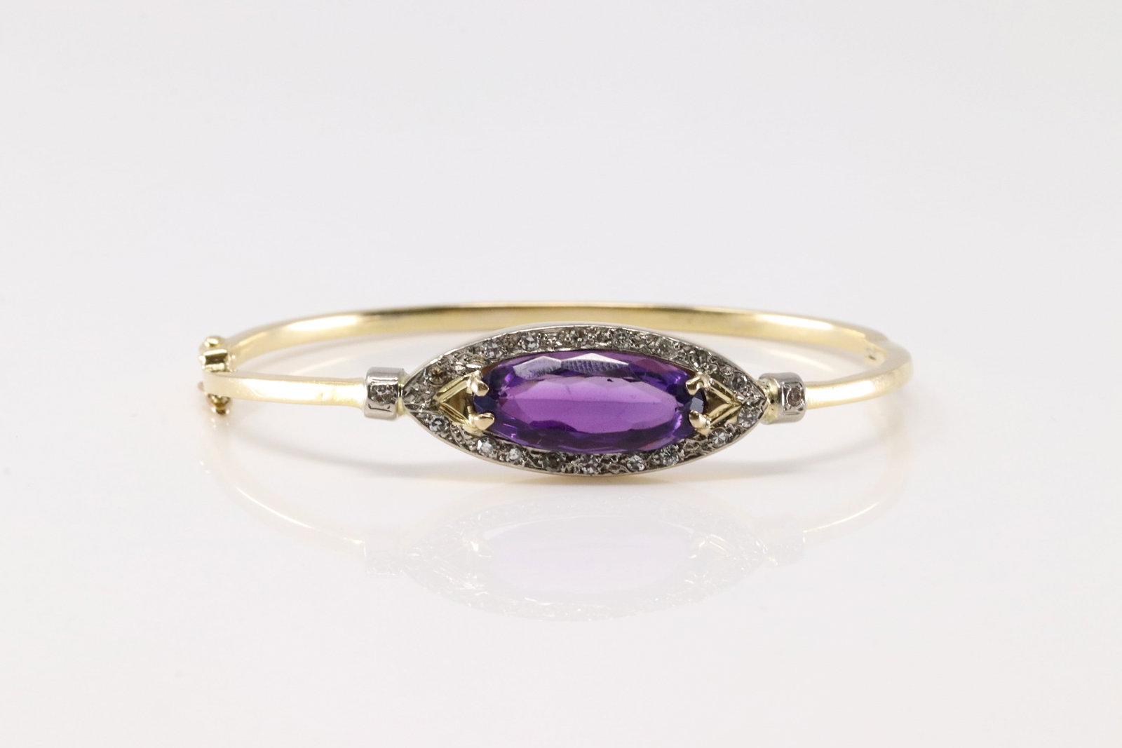 Amethyst & Diamond Bangle Bracelet 18Kt.: Ladies 18Kt Yellow Gold Amethyst & Diamond Bangle Bracelet. This Elegant Bangle Bracelet has 1 Oval Amethyst In The Center Surrounded By 18 Round Brilliant Diamonds. Diamonds Approx Weight: 0.30 ctw T
