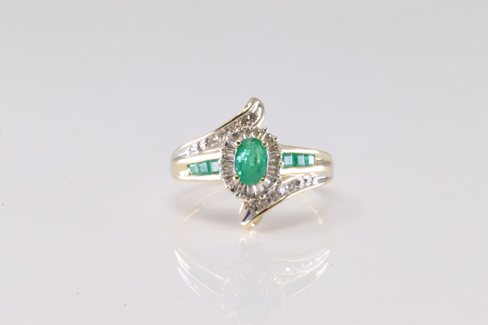 Emerald & Diamond Ring 10Kt.: Ladies 10Kt Yellow Gold Emerald & Diamond Ring. This Ring has Green Emeralds with Baguette and Round Diamonds. Ring size: 7.00. Total weight: 2.63 Grams.