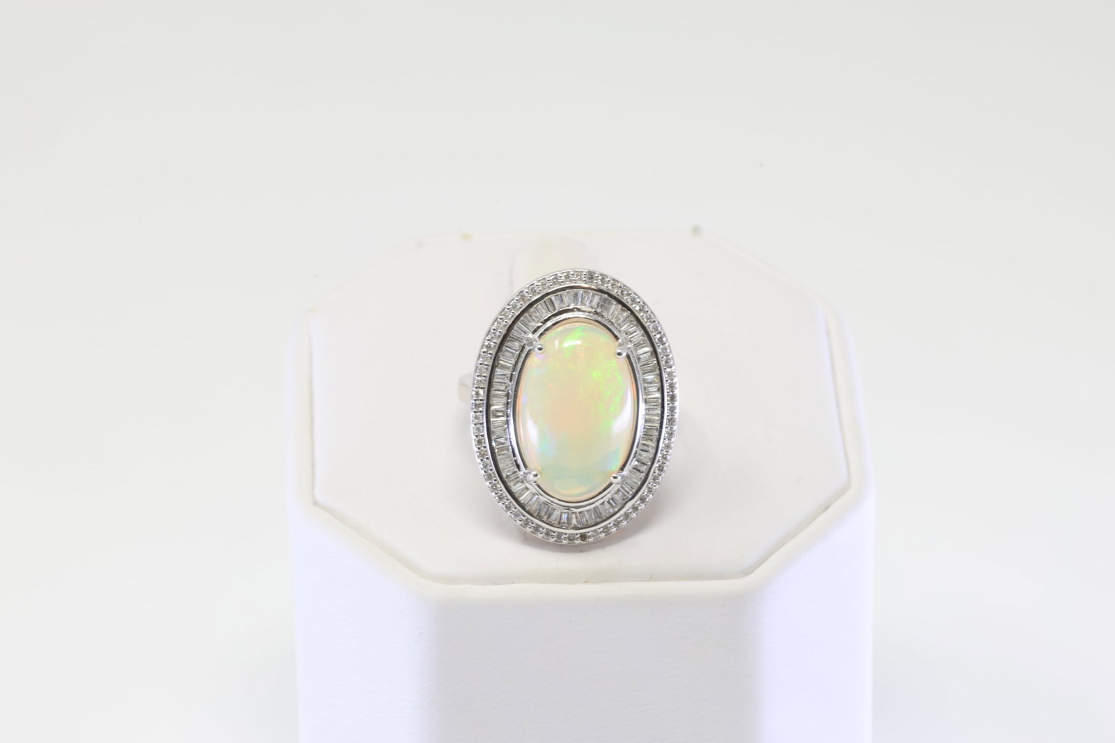 Opal & Diamond Ring 14Kt.: Ladies 14Kt White Gold Opal & Diamond Ring. Ring has one Oval Opal with Round Brlliants & Baguette Cut Diamonds. Diamonds weight approx: 1.75-2.00ctw. Ring size: 6.50. Total weight: 7.20 Grams.