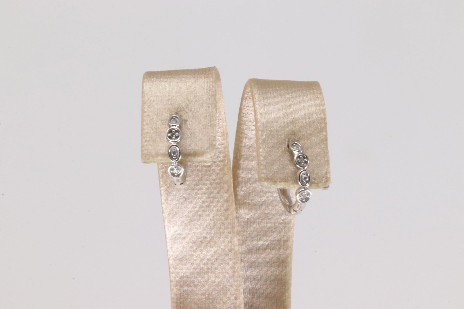 Diamond Hoop Earring 14Kt.: Ladies 14Kt White Gold Diamond Hoop Earring. This Charming Hoop Earring's has Sparkling Diamonds. Diamonds weight: 0.03ctw.
