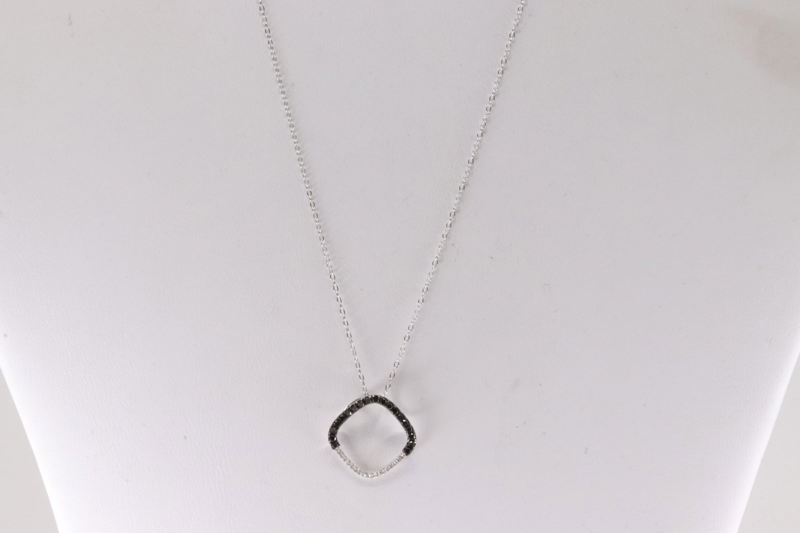 Multi-Color Diamond Necklace 14Kt.: 14Kt White Gold Multi-Color Diamond Necklace. This Necklace has A Charm with 36 Sparkling Diamonds Black & White. Diamonds weight: 0.18ctw. Necklace length: 18.00"