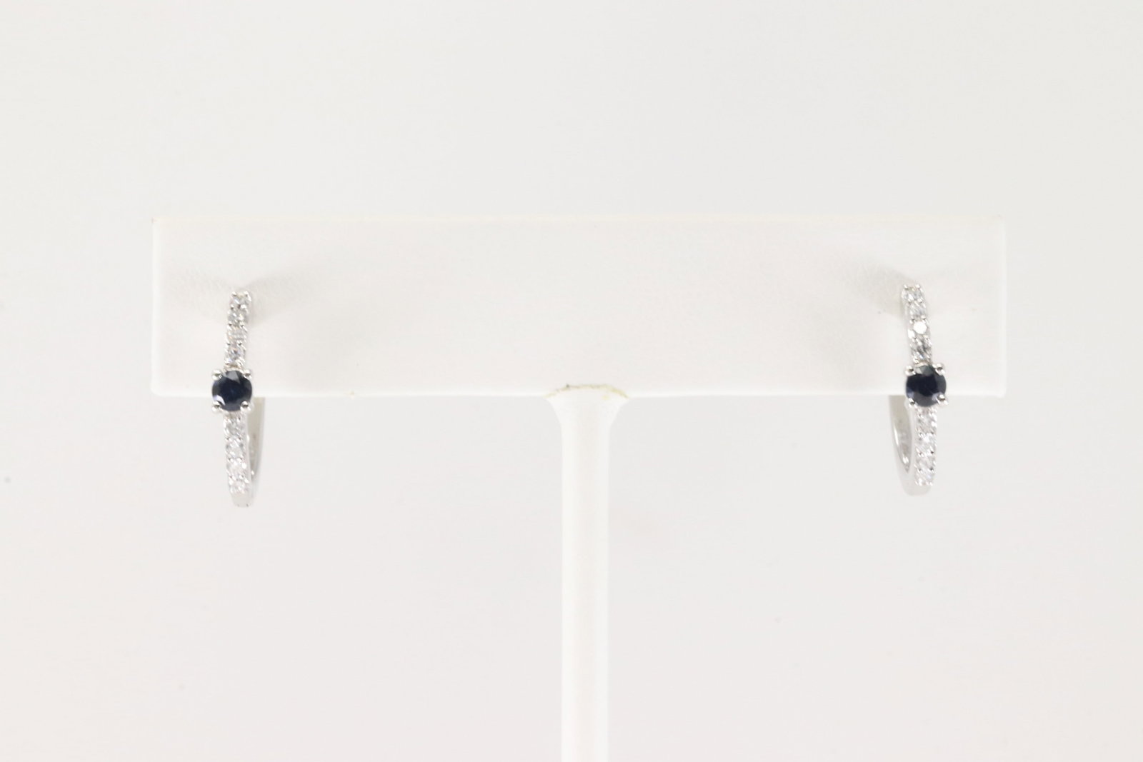 Sapphire & Diamond Hoop Earring 14Kt.: Ladies 14Kt White Gold Sapphire & Diamond Hoop Earring. This Earring's have 16 Round Sparkling Diamonds & Beautiful Blue Sapphire Gemstones In The Middle. Diamond Weight: 0.25ct. Sapphire Weight: