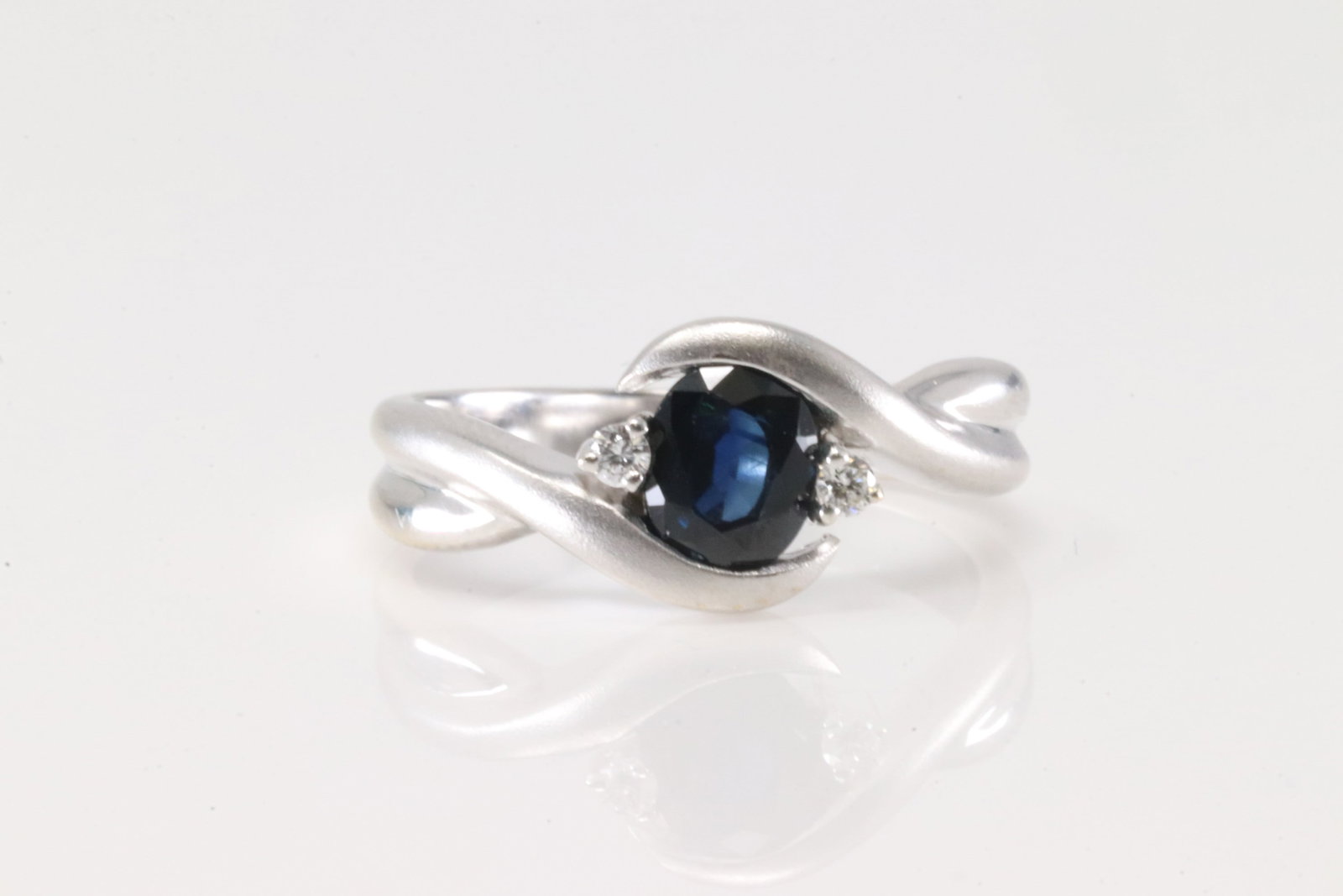 Sapphire & Diamond Ring 18Kt.: Ladies 18Kt White Gold Sapphire & Daimond Ring. This elegant ring has round sapphire with 2 sparkling diamonds. Ring size: 5.50. Total weight: 4.50 Grams.