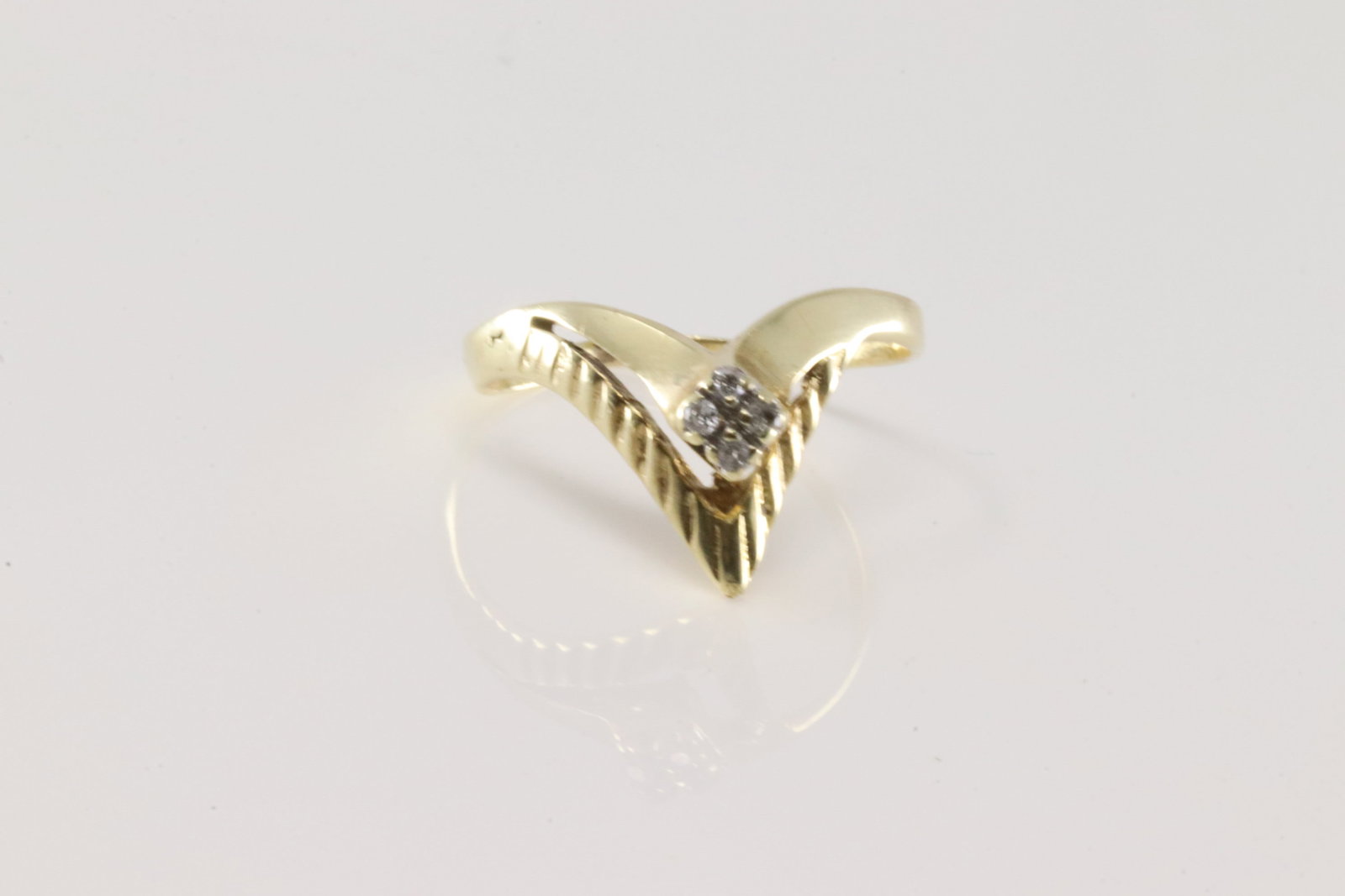 Diamond Ring 14Kt.: Ladies 14Kt Yellow Gold Diamond Ring. This ring has V design with 4 round diamonds. Ring size: 8.25. Total weight: 2.30 Grams.
