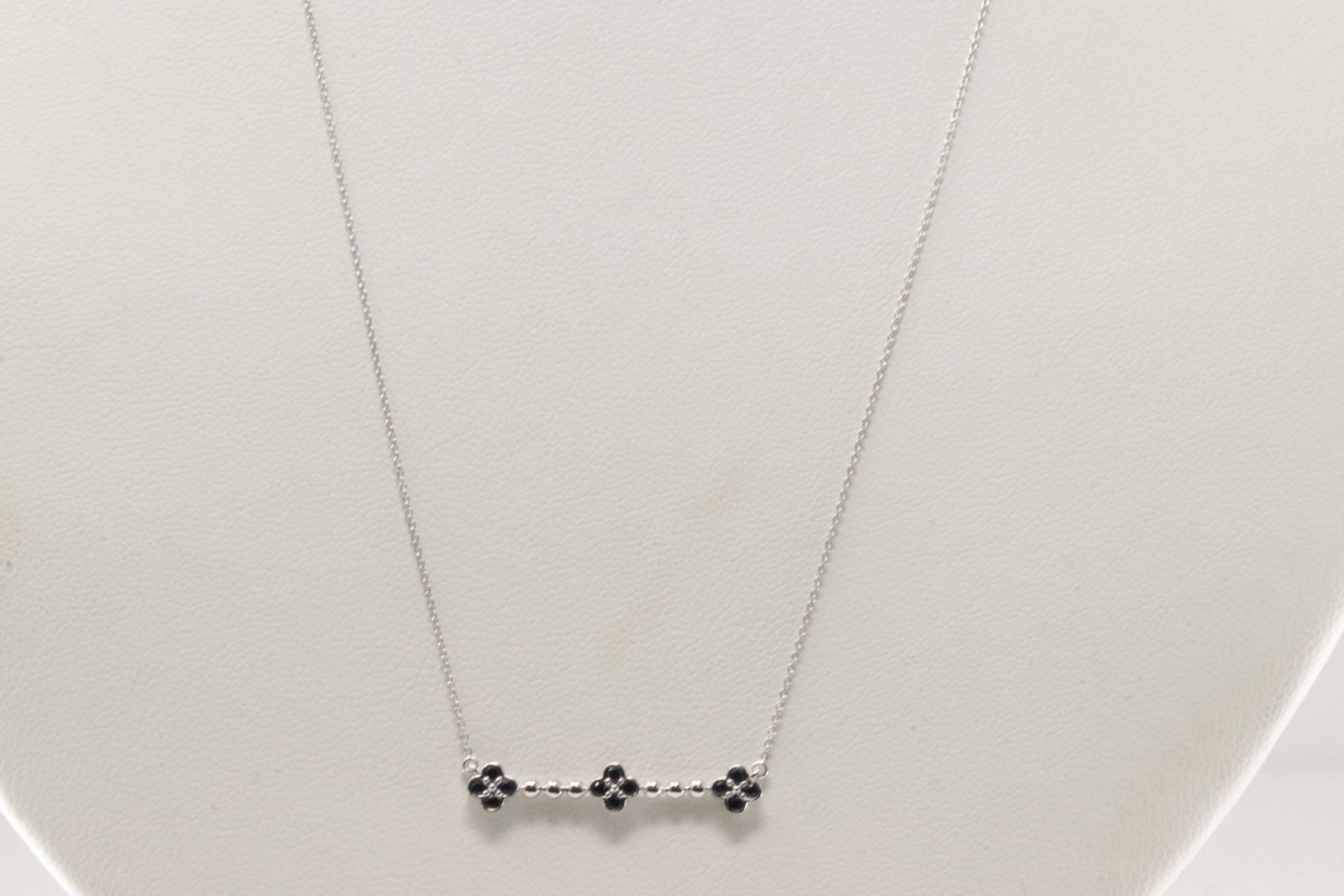 Sapphire Necklace 10Kt.: Ladies 10Kt White Gold Sapphire Necklace. This Necklace has a Charm Flowers Design with Blue Sapphires. Necklace length: 18.00"