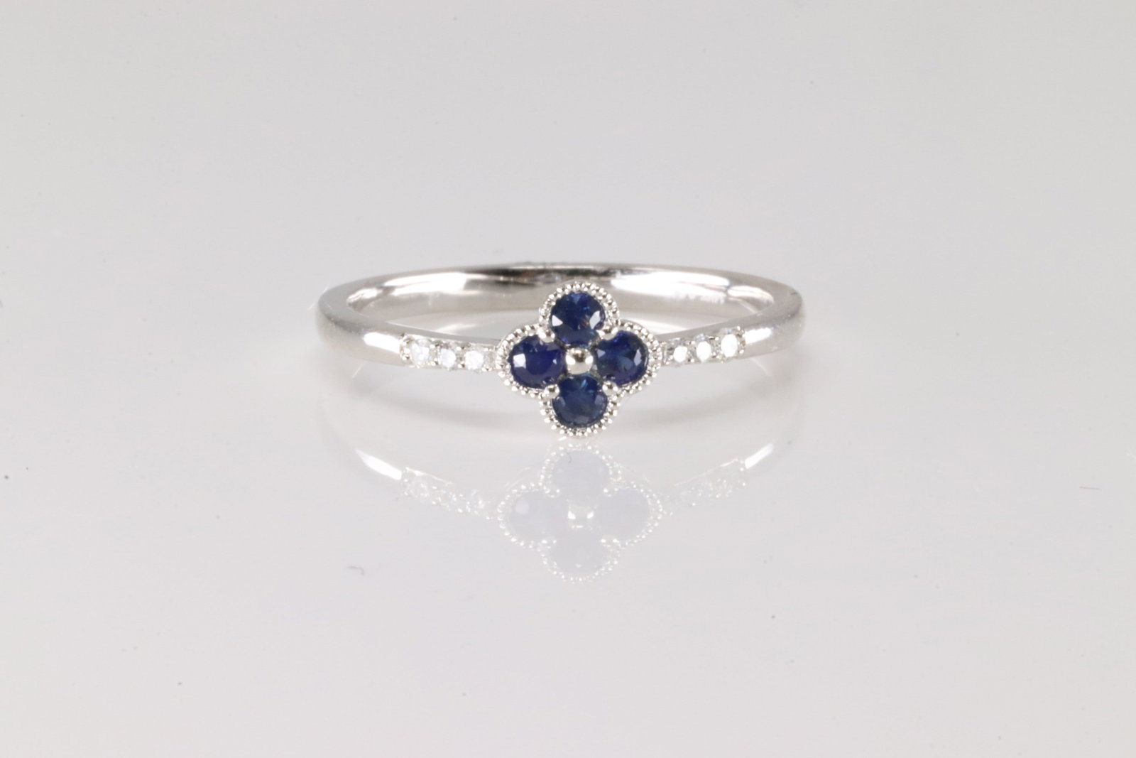Sapphire & Diamond Ring 14Kt: 14Kt White Gold Sapphire & Diamond Ring. This ring has clover design with 4 blue sapphire and 6 round diamonds. Diamonds weight approx: 0.04ctw. Sapphires weight approx: 0.17ctw. Ring size: 6.25.