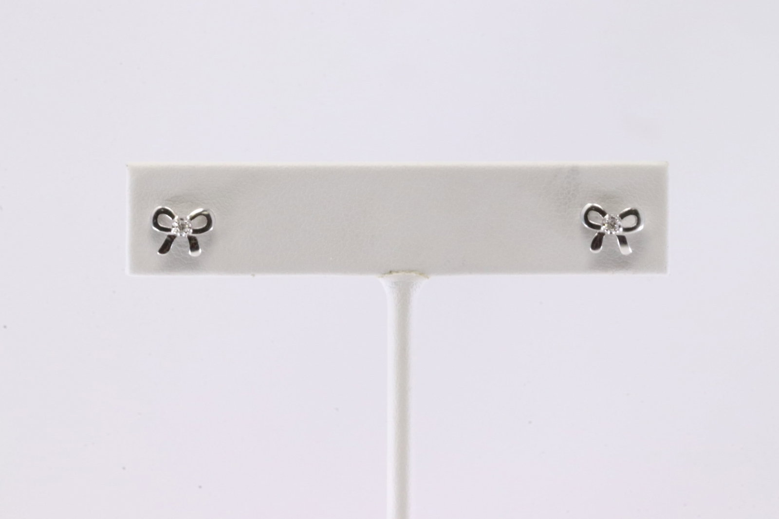 Bow Diamond Stud Earring 14Kt.: 14Kt White Gold Bow Diamond Stud Earring. This Charming Earring has Bow Design with Sparkling Diamonds.